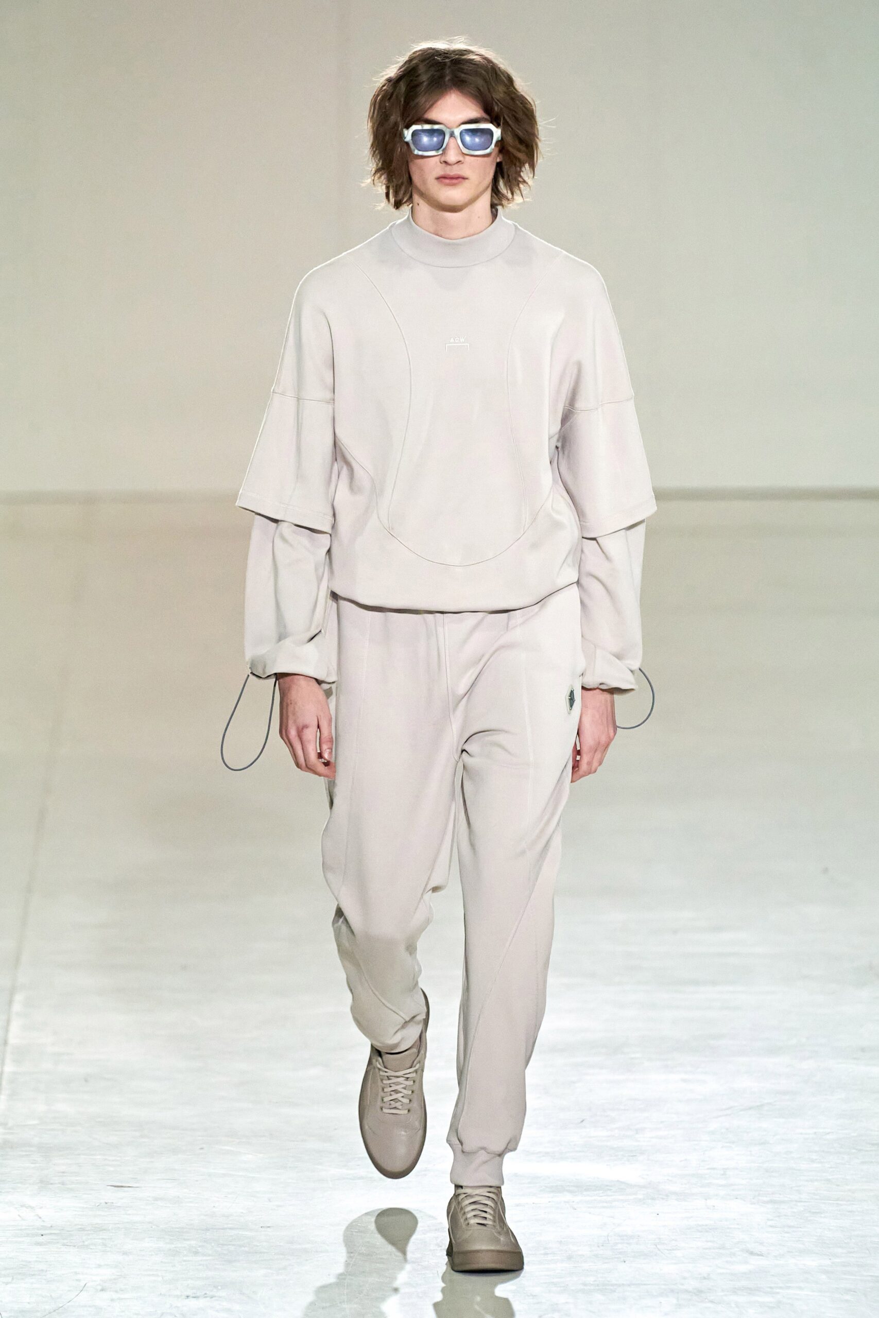A relaxed beige cotton sweater with long sleeves paired with matching pants.