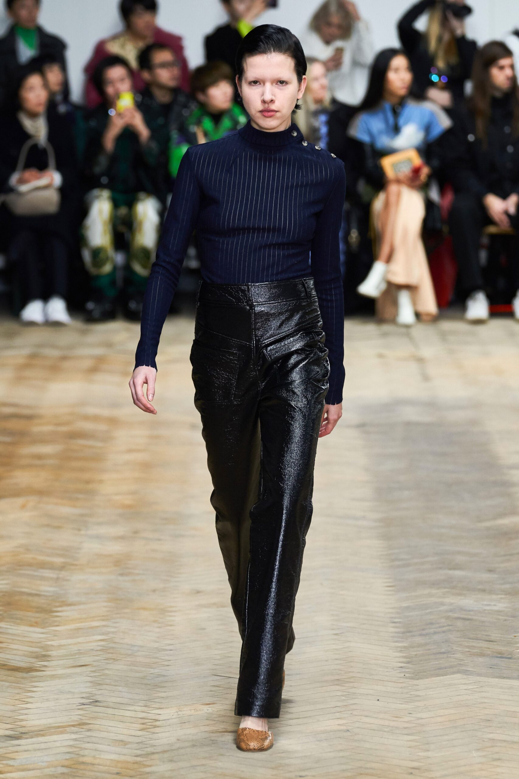 fitted navy turtleneck top and black leather pants