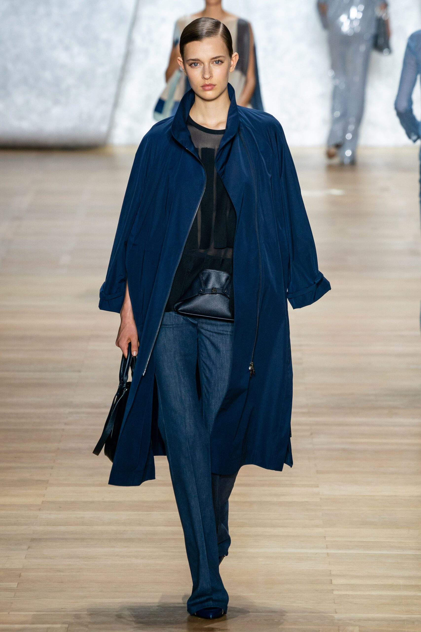 blue coat with black top and denim pants