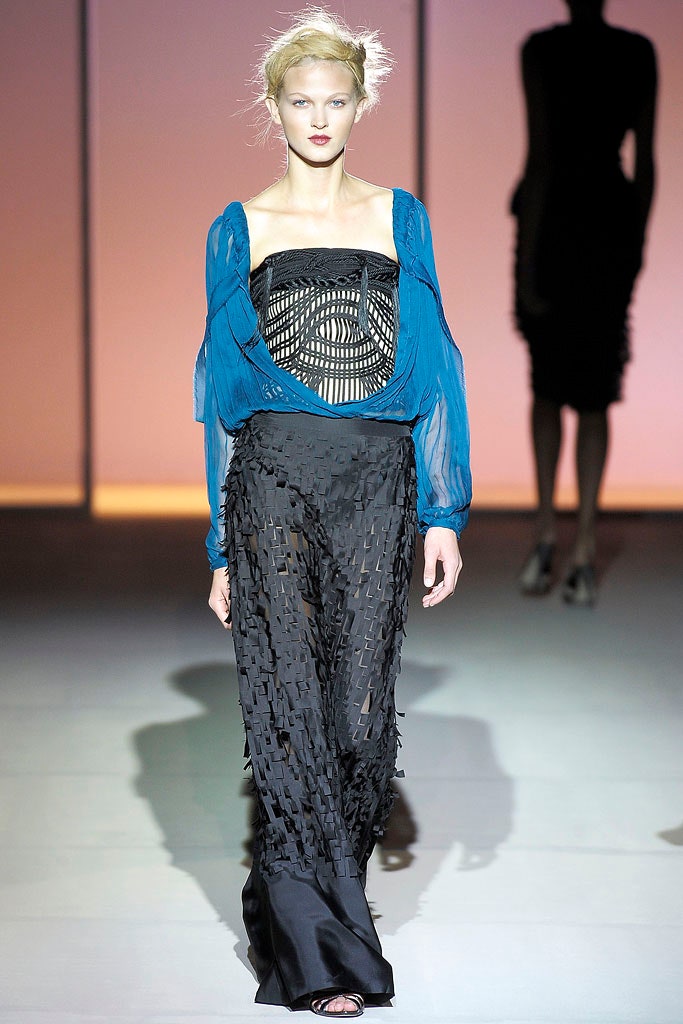 blue silk off-shoulder top with black pleated pants