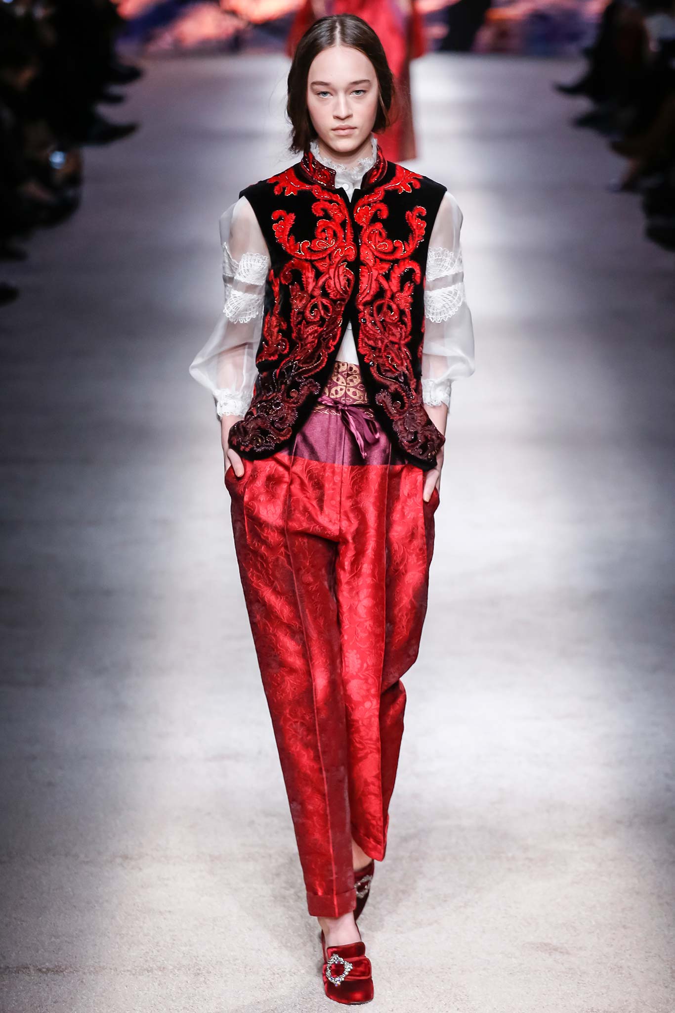 black embroidered vest and red pants