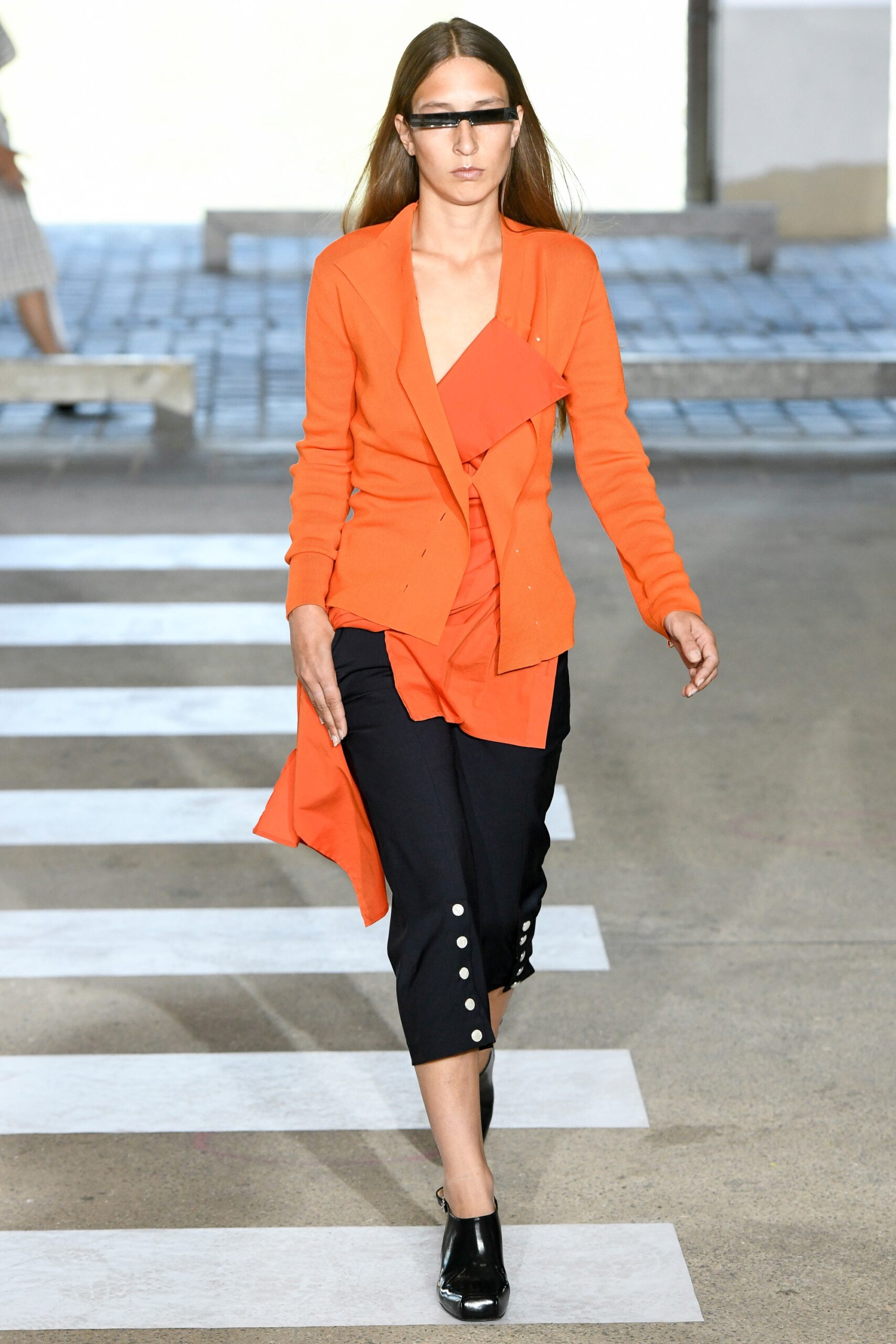 orange fitted blazer with black pants