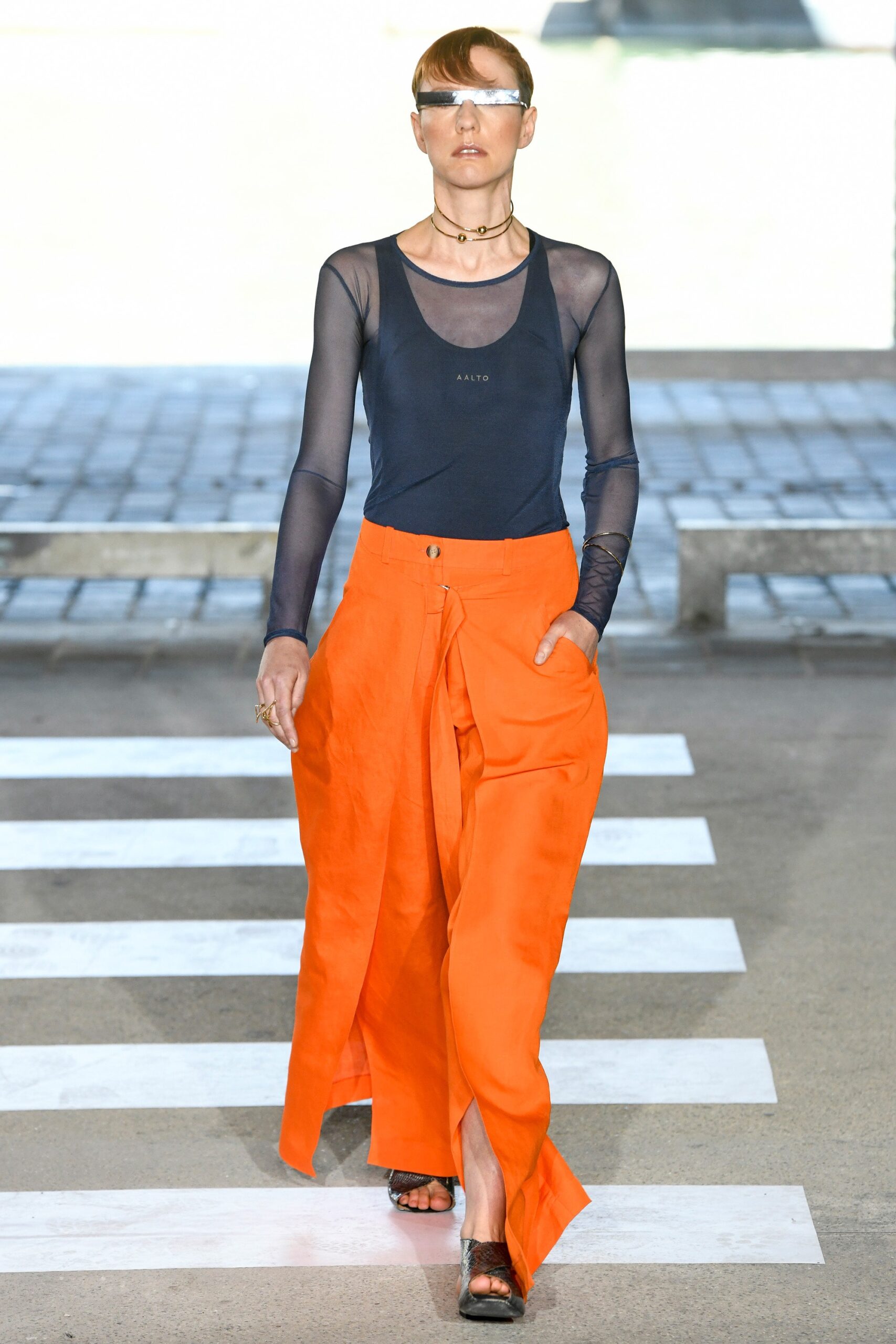 black mesh fitted top and orange relaxed pants