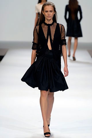 black fitted top and pleated skirt
