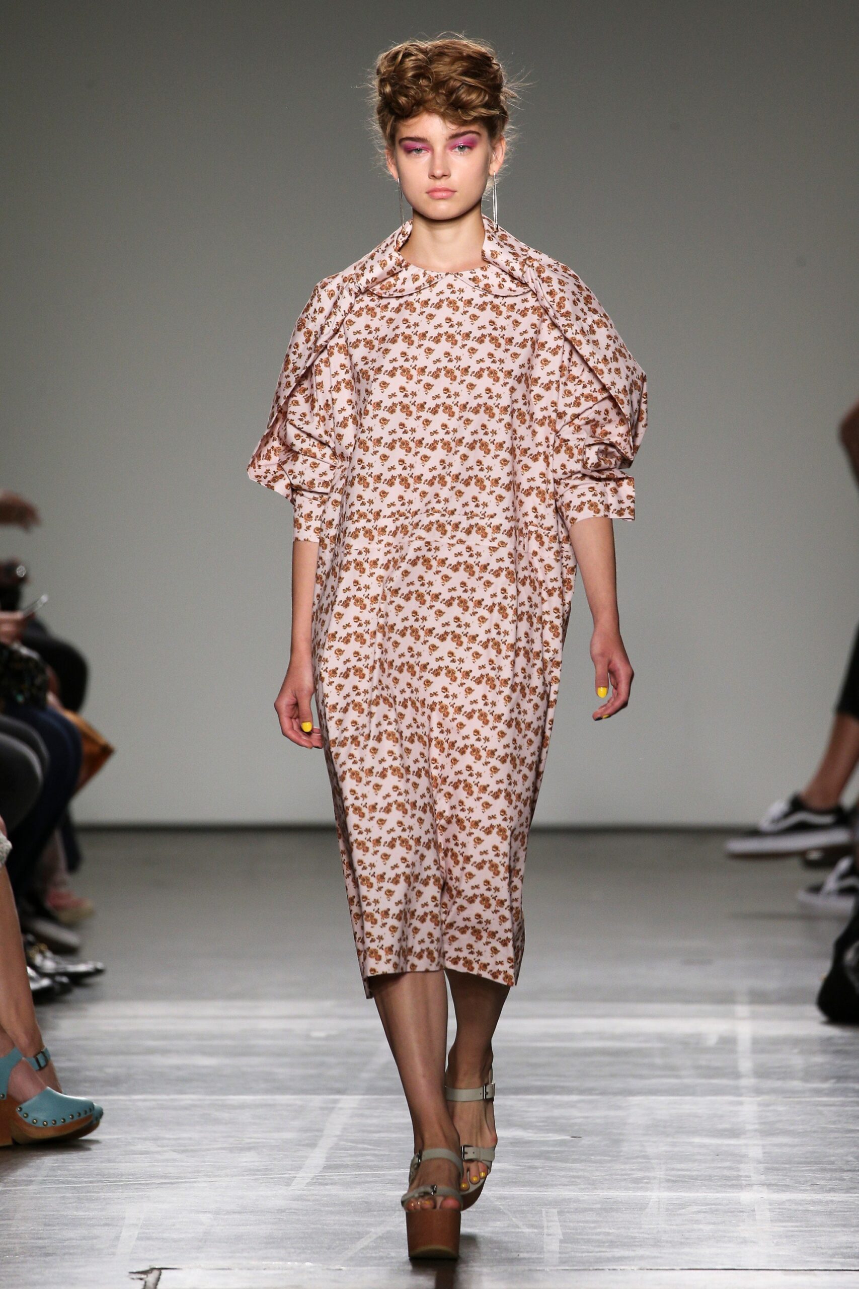 A relaxed pink floral dress with long sleeves and a collared neckline.