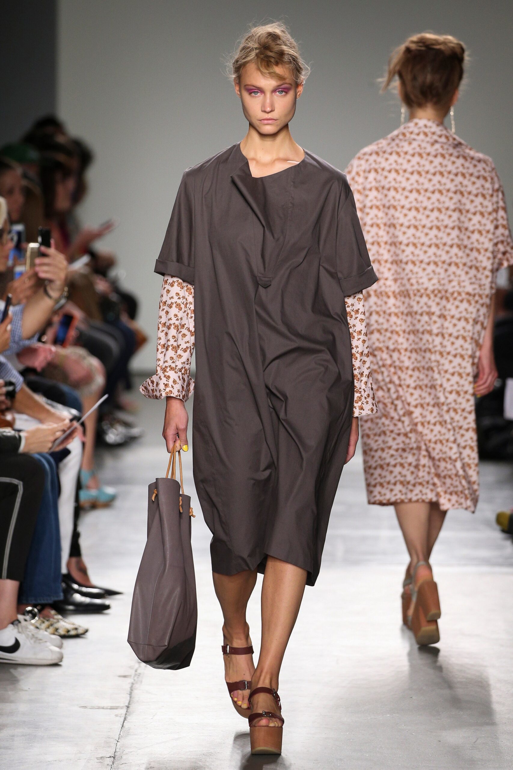 A relaxed brown cotton dress with short sleeves and an asymmetric design.
