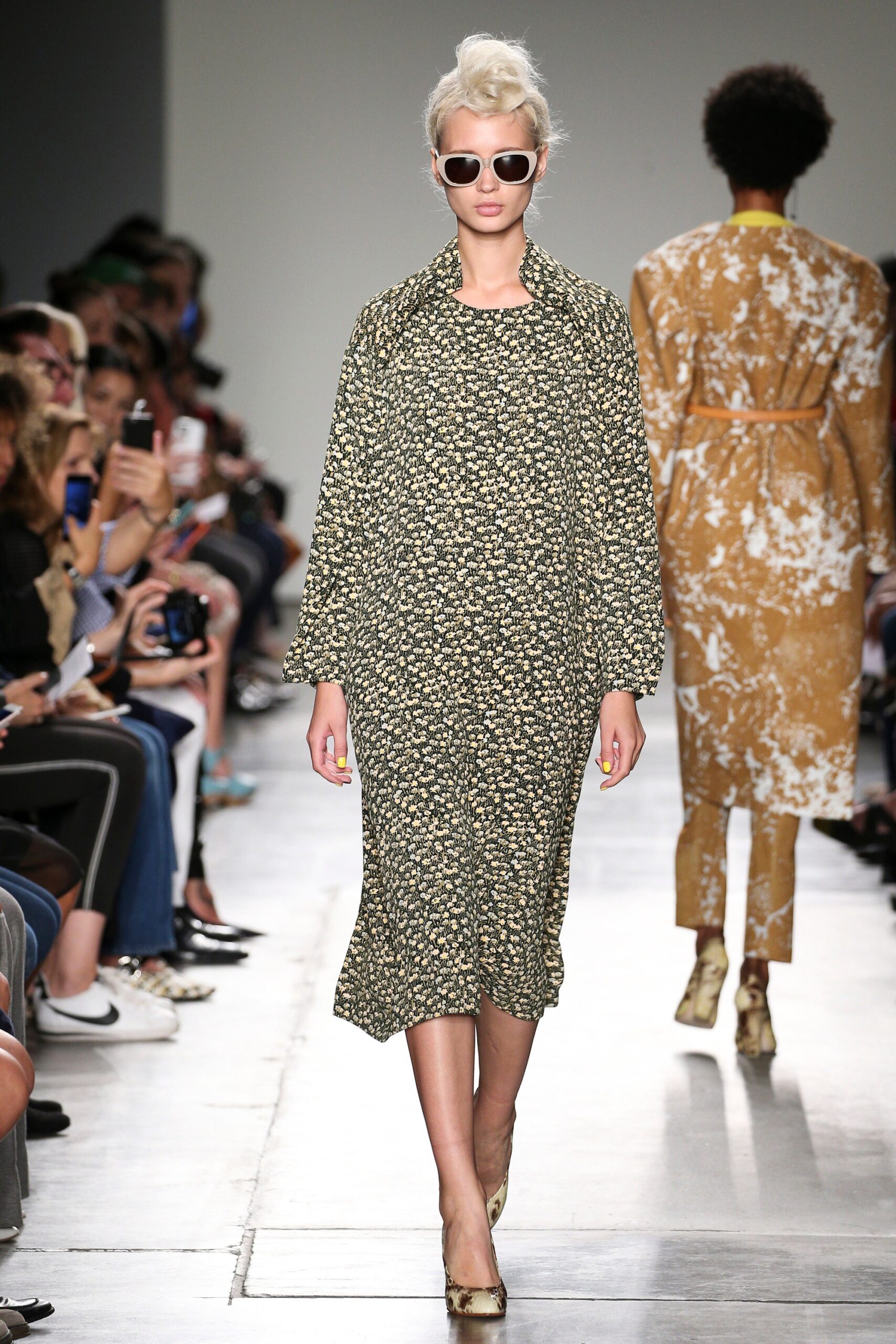 A relaxed green floral dress with long sleeves and a collared neckline.