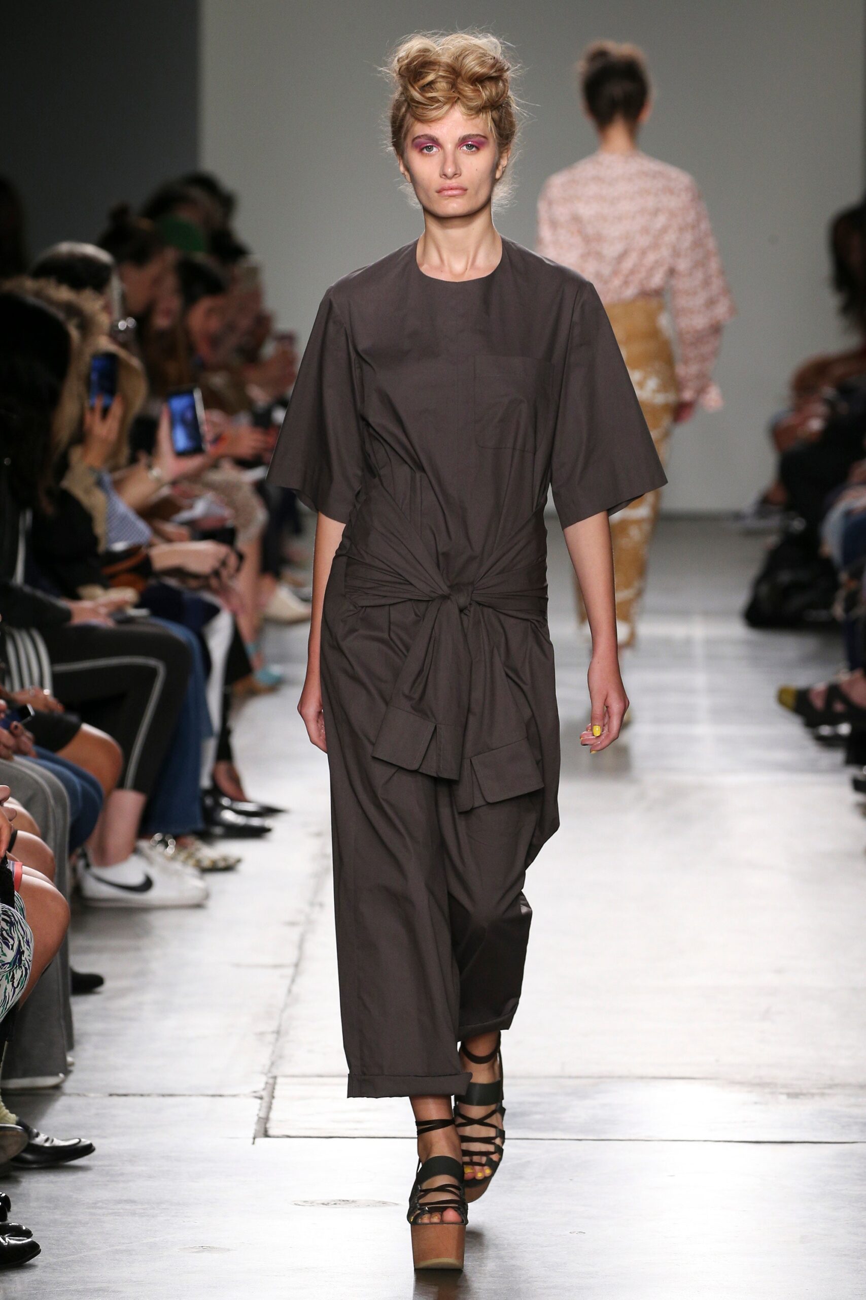 A relaxed brown cotton dress with short sleeves and an asymmetric design.