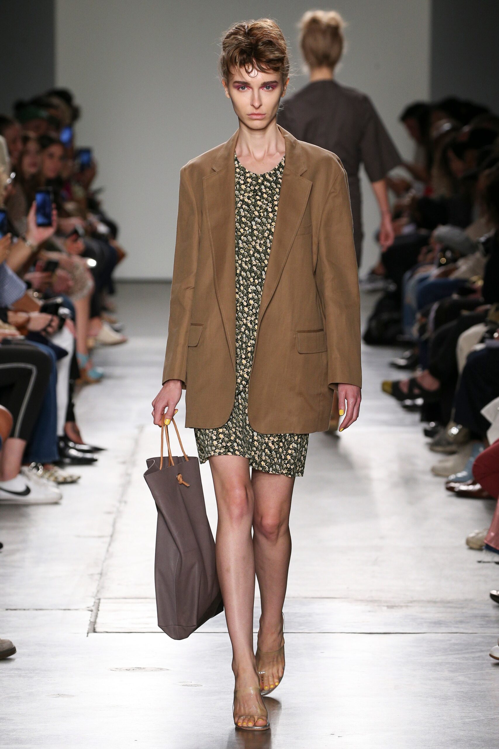 A relaxed brown floral dress paired with a matching jacket, perfect for a casual runway look.