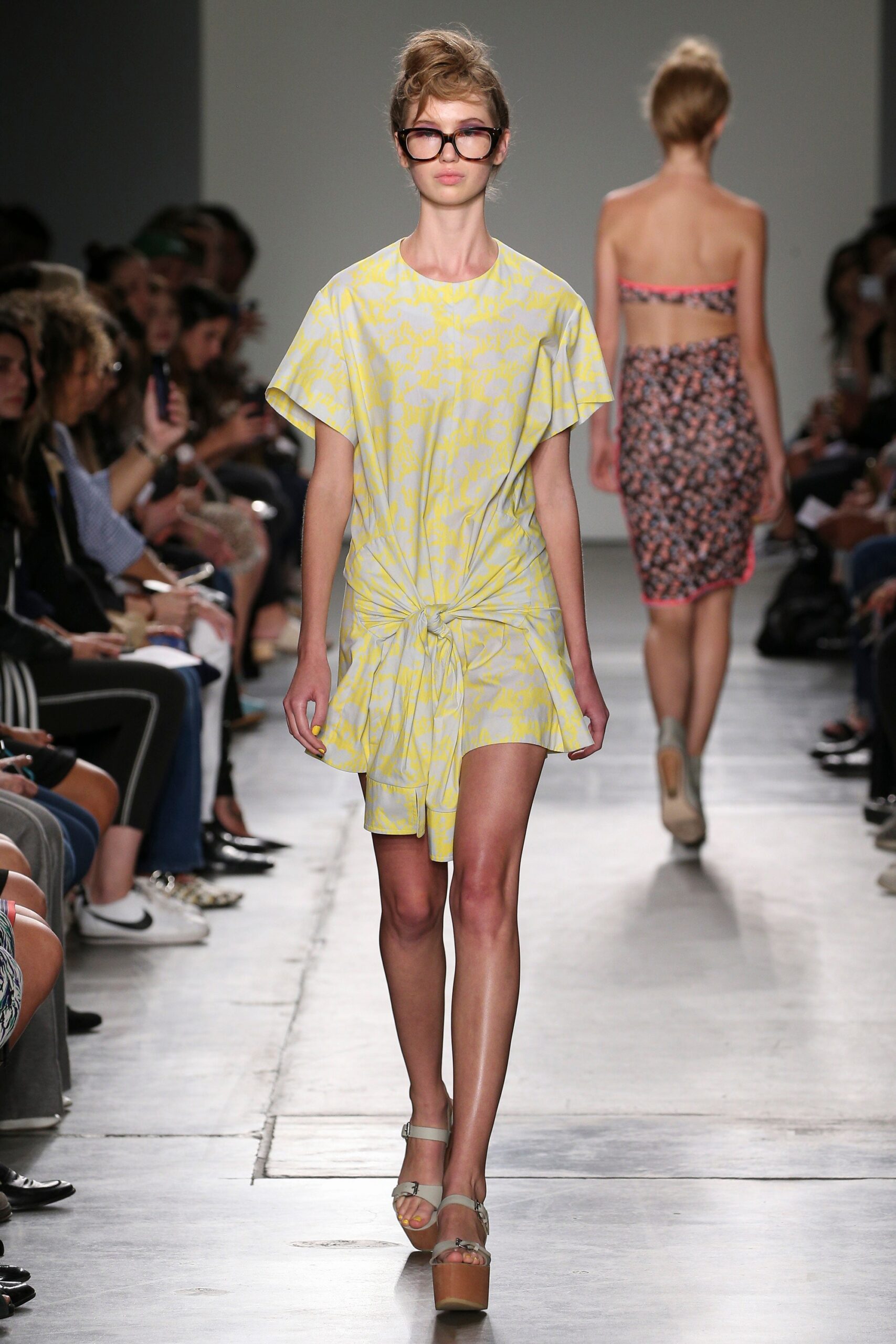 A relaxed yellow dress with short sleeves and a V-neckline featuring a playful print.