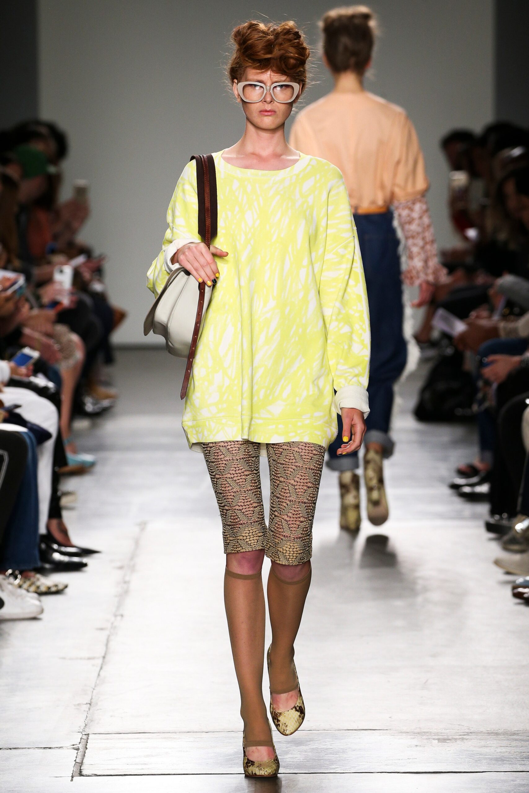 A relaxed yellow printed long-sleeve top paired with beige leggings for a casual look.