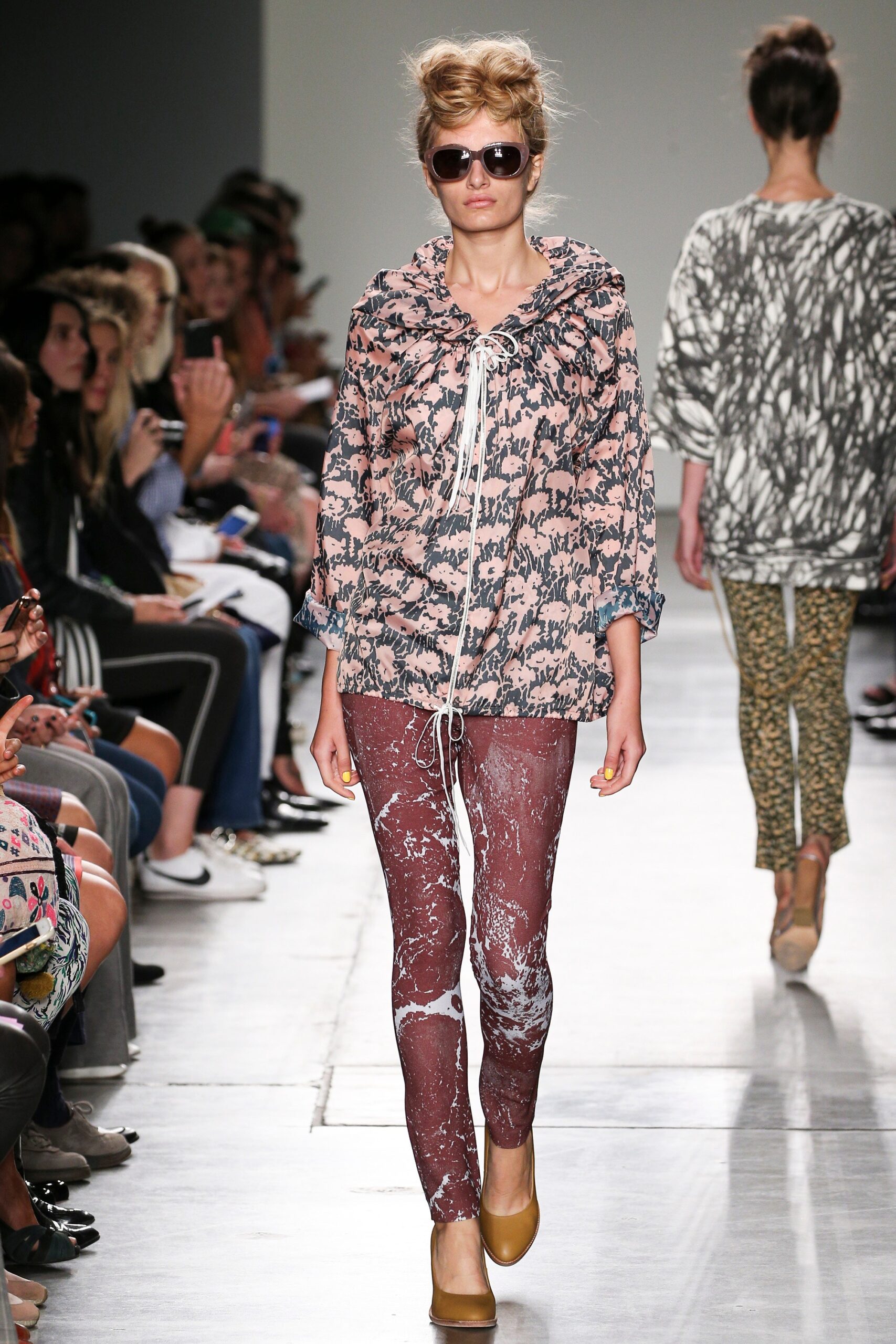 A relaxed pink printed top paired with brown pants, featuring a long-sleeve and collared design.