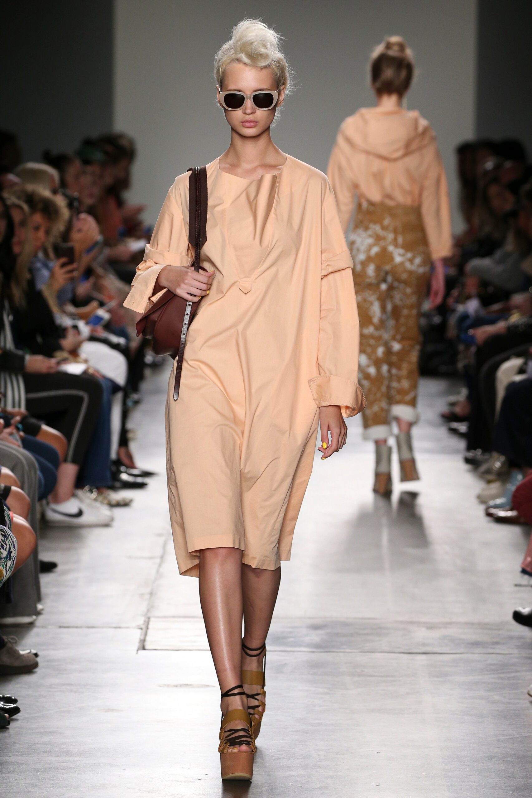 A relaxed peach long-sleeve dress with a V-neckline and asymmetric design.