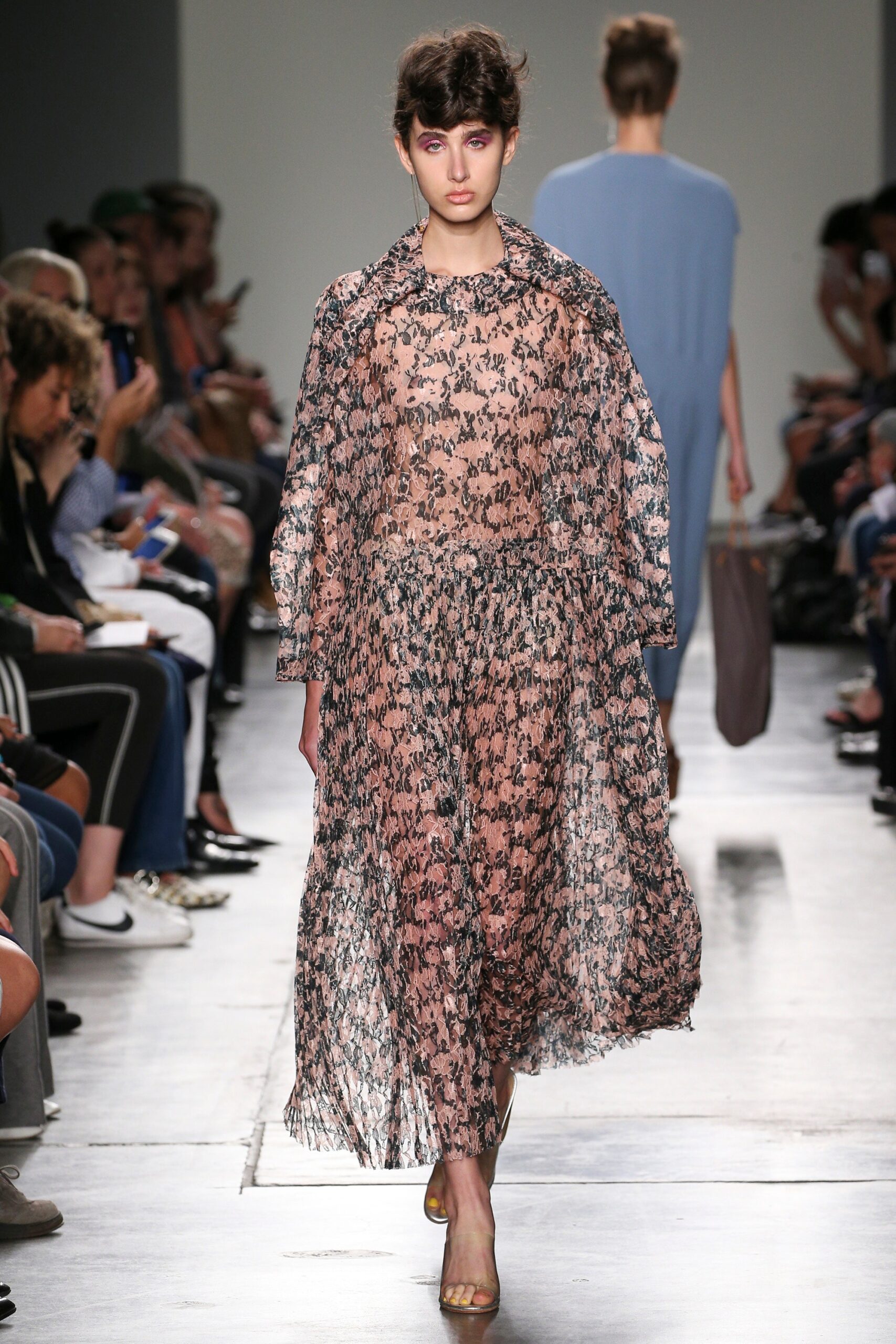 A relaxed pink floral dress layered with a long-sleeve collared coat.