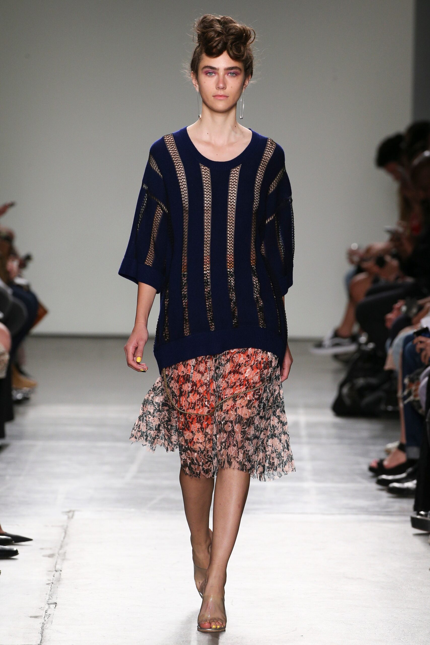 A relaxed blue top with short sleeves paired with a layered floral skirt.