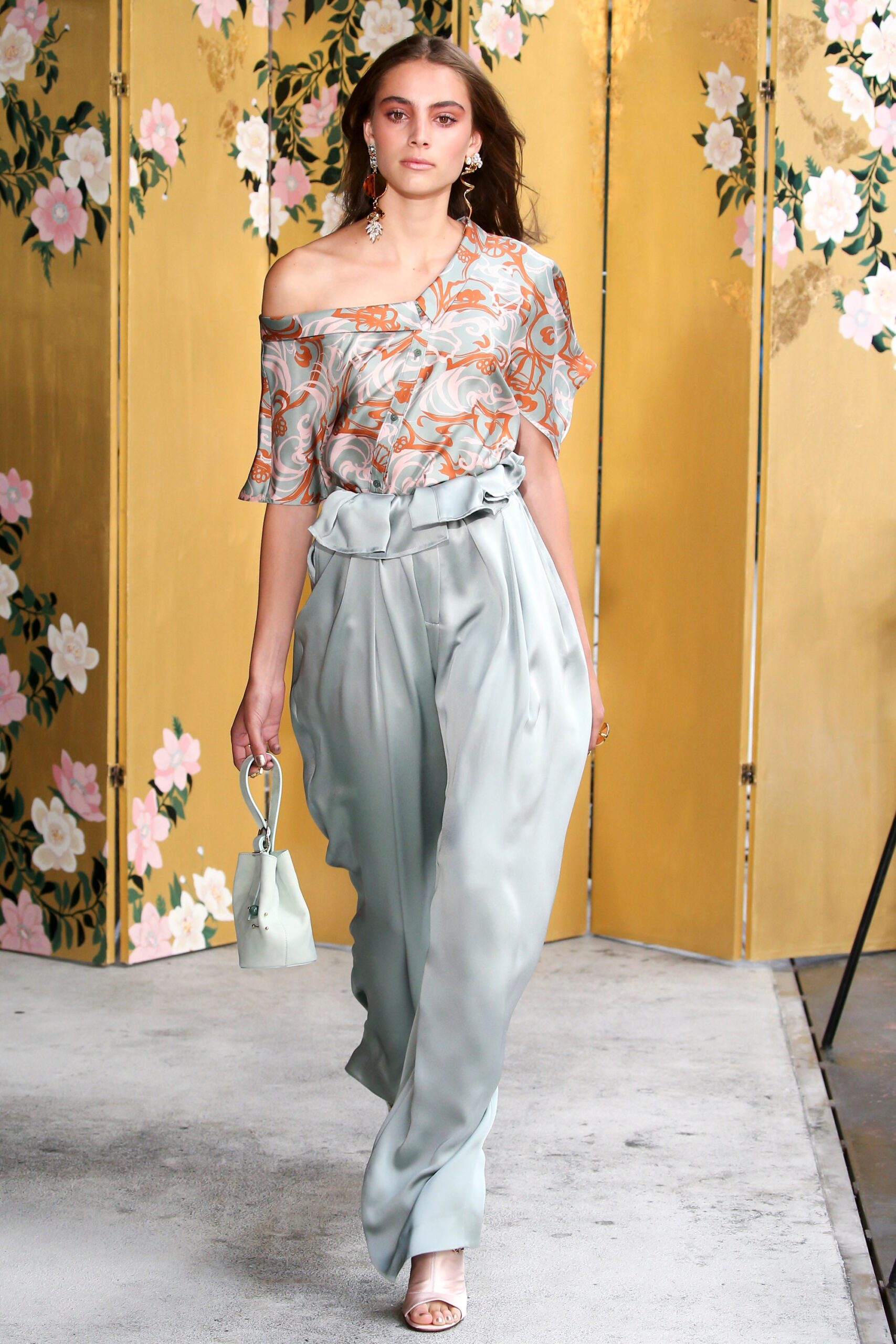 multi-colored silk off-shoulder top with gray wide-leg pants