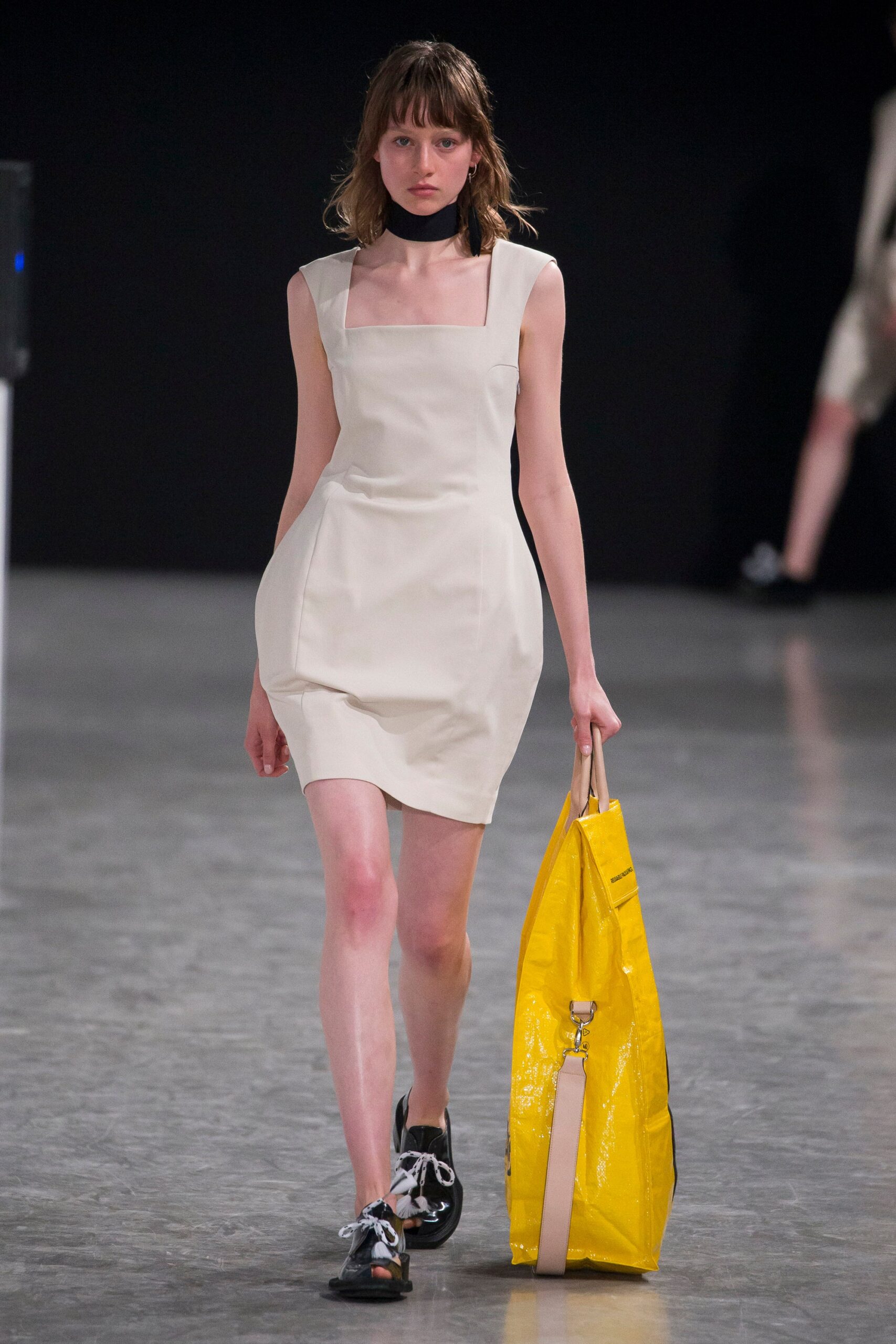 fitted white mini dress with yellow bag