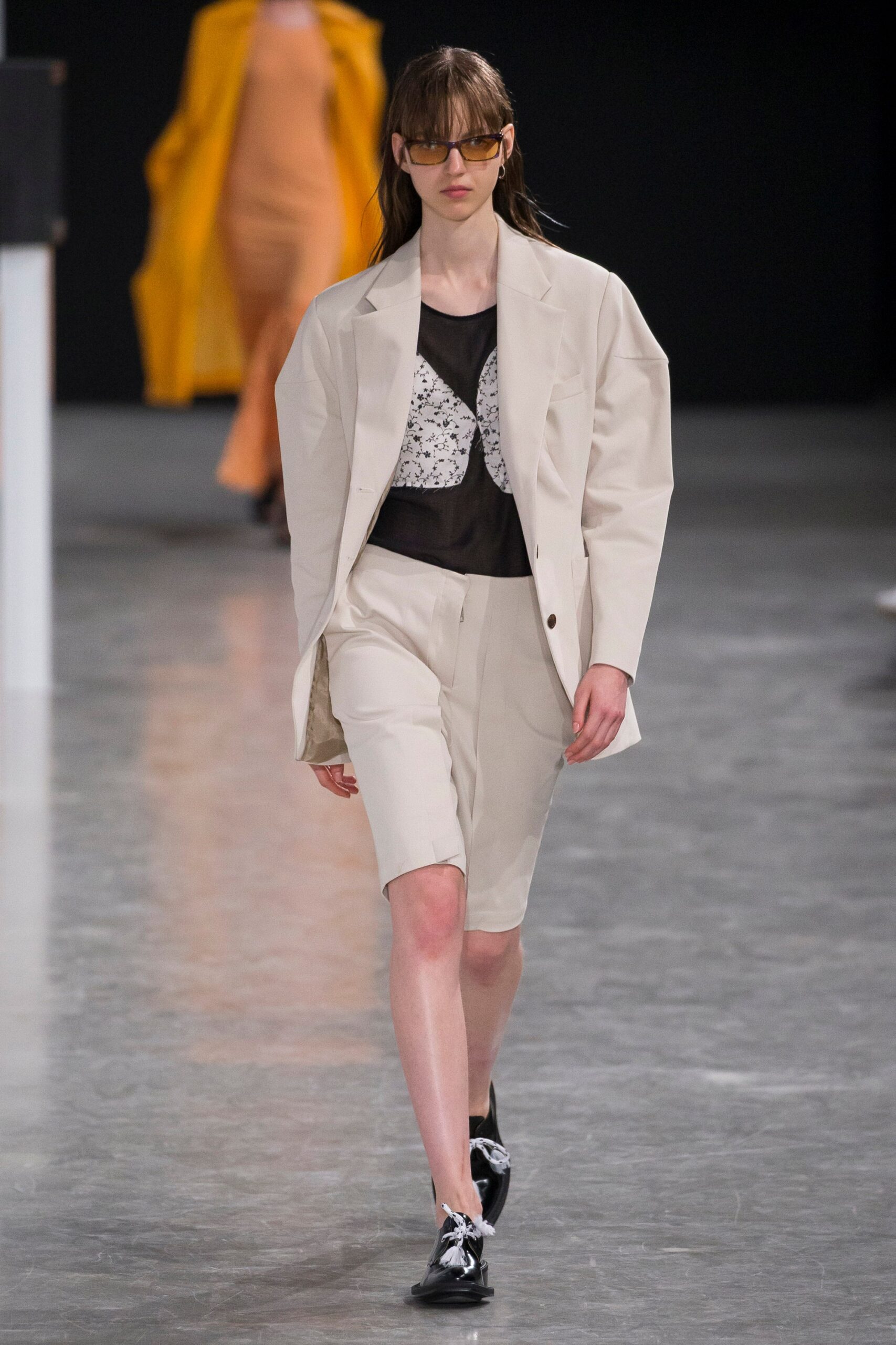 beige blazer and shorts with black top