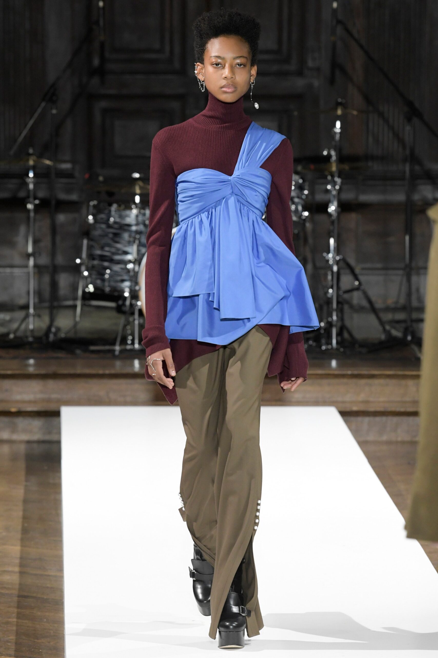 blue draped top with brown pants