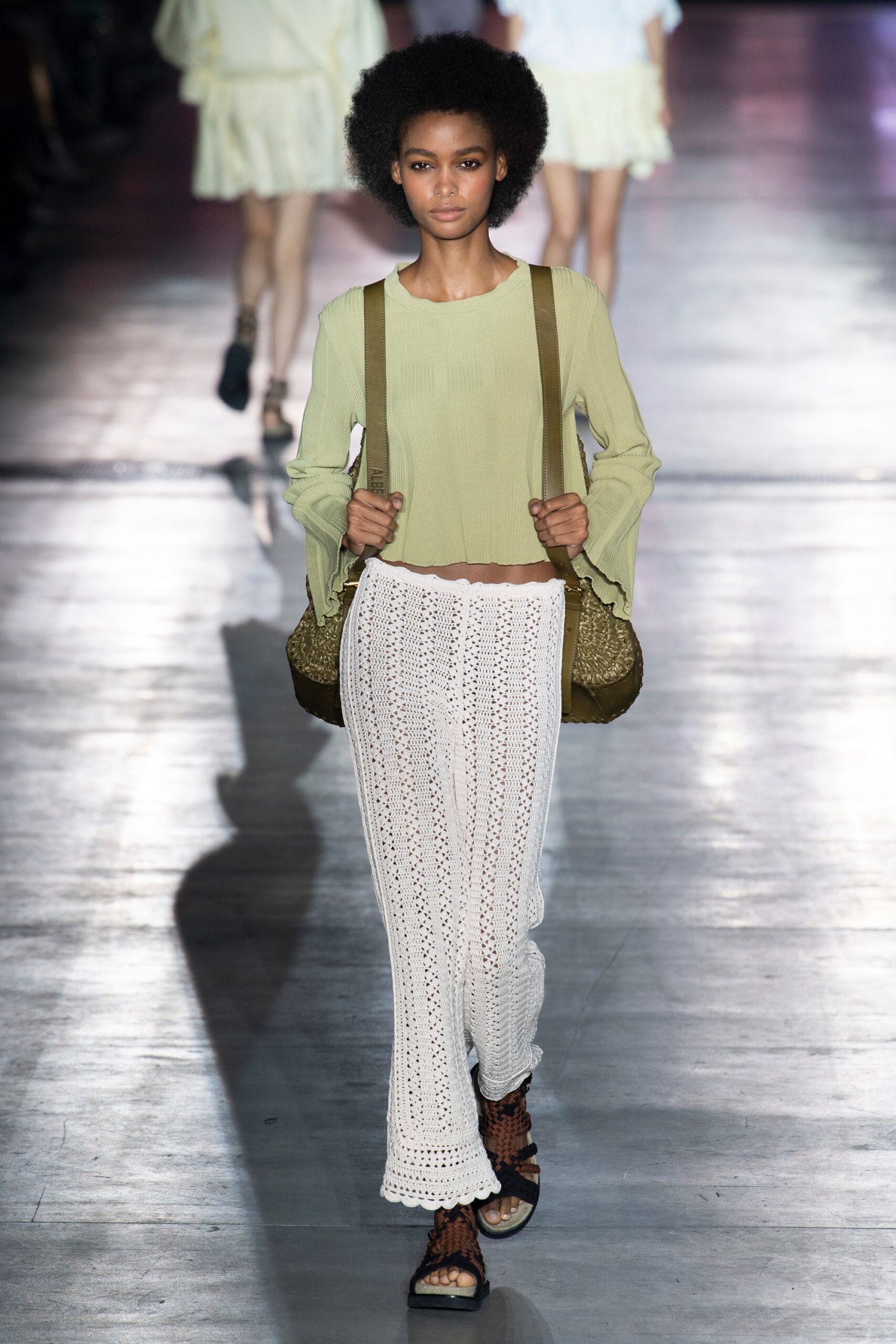 green relaxed top with white crochet pants