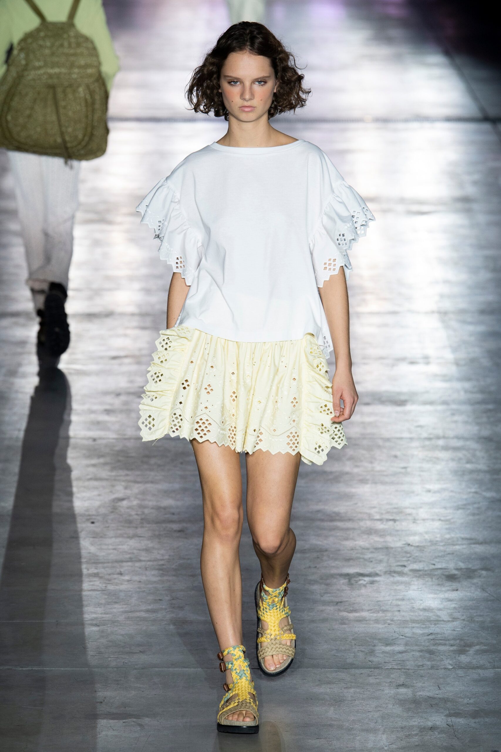 white relaxed top with yellow mini skirt