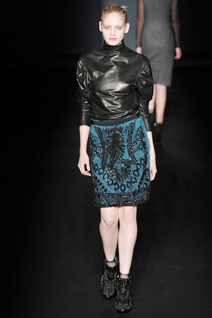 black leather fitted top and blue embroidered skirt