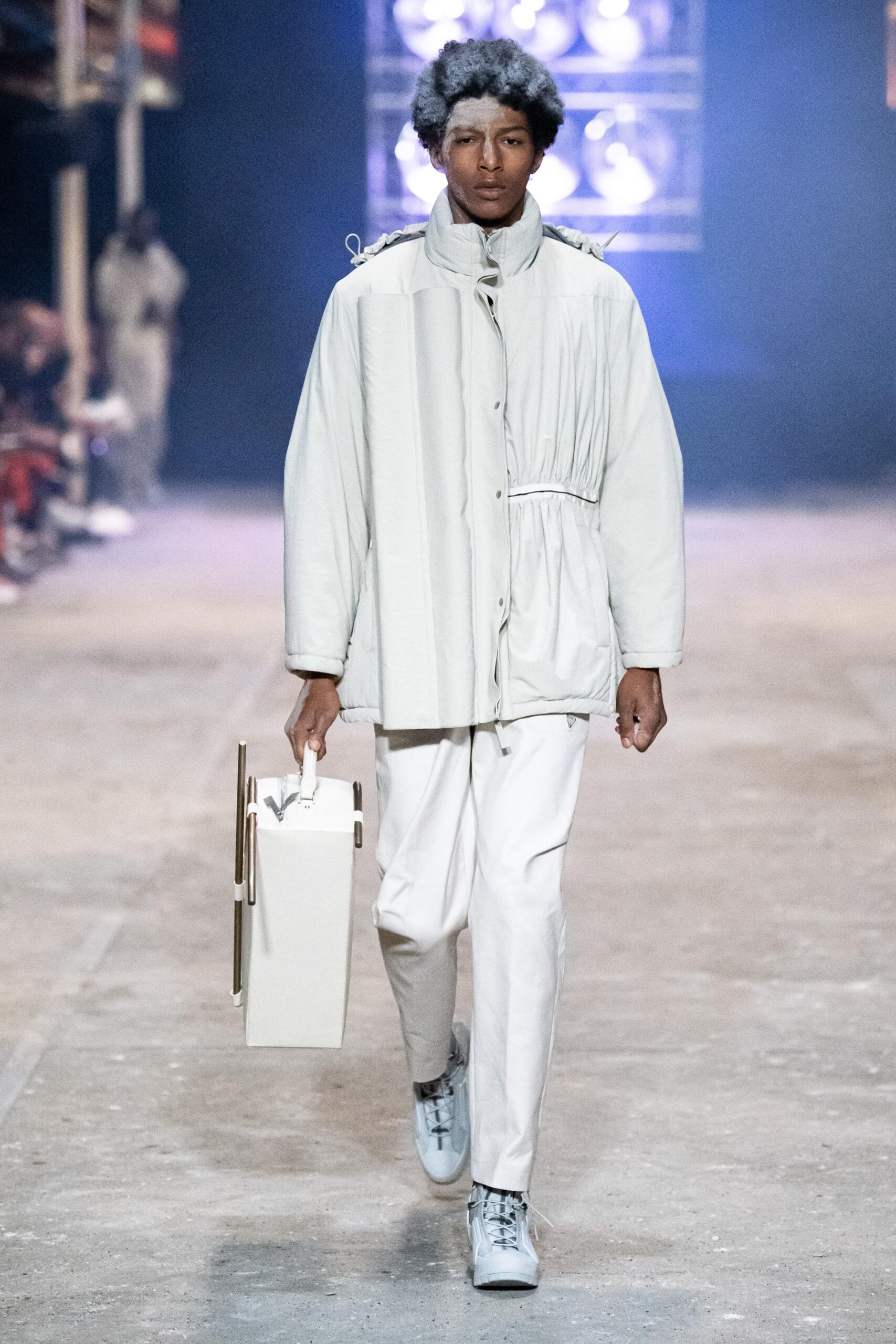 A relaxed white jacket with long sleeves and collared design paired with matching pants.