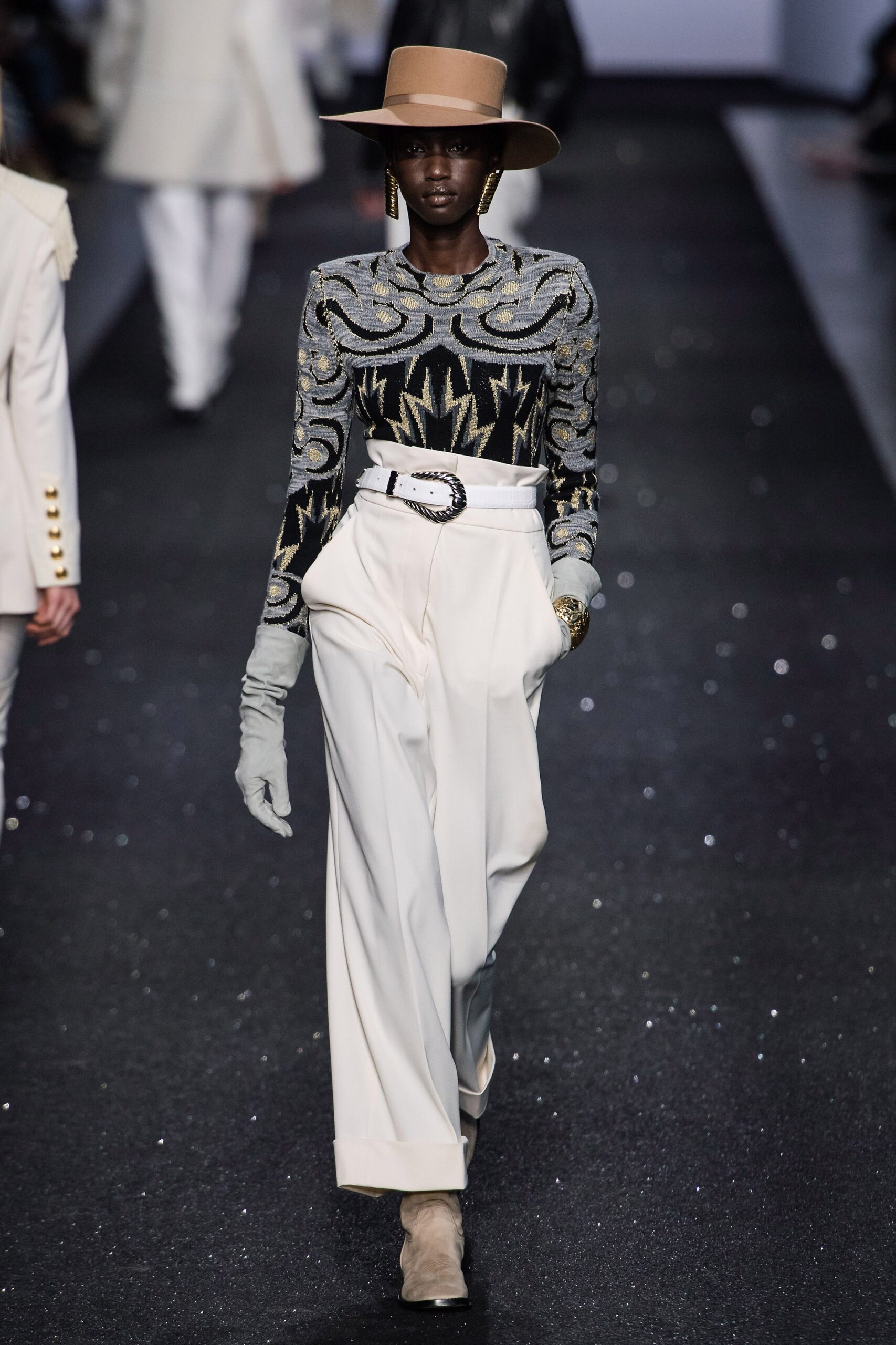 black embroidered top with white pants