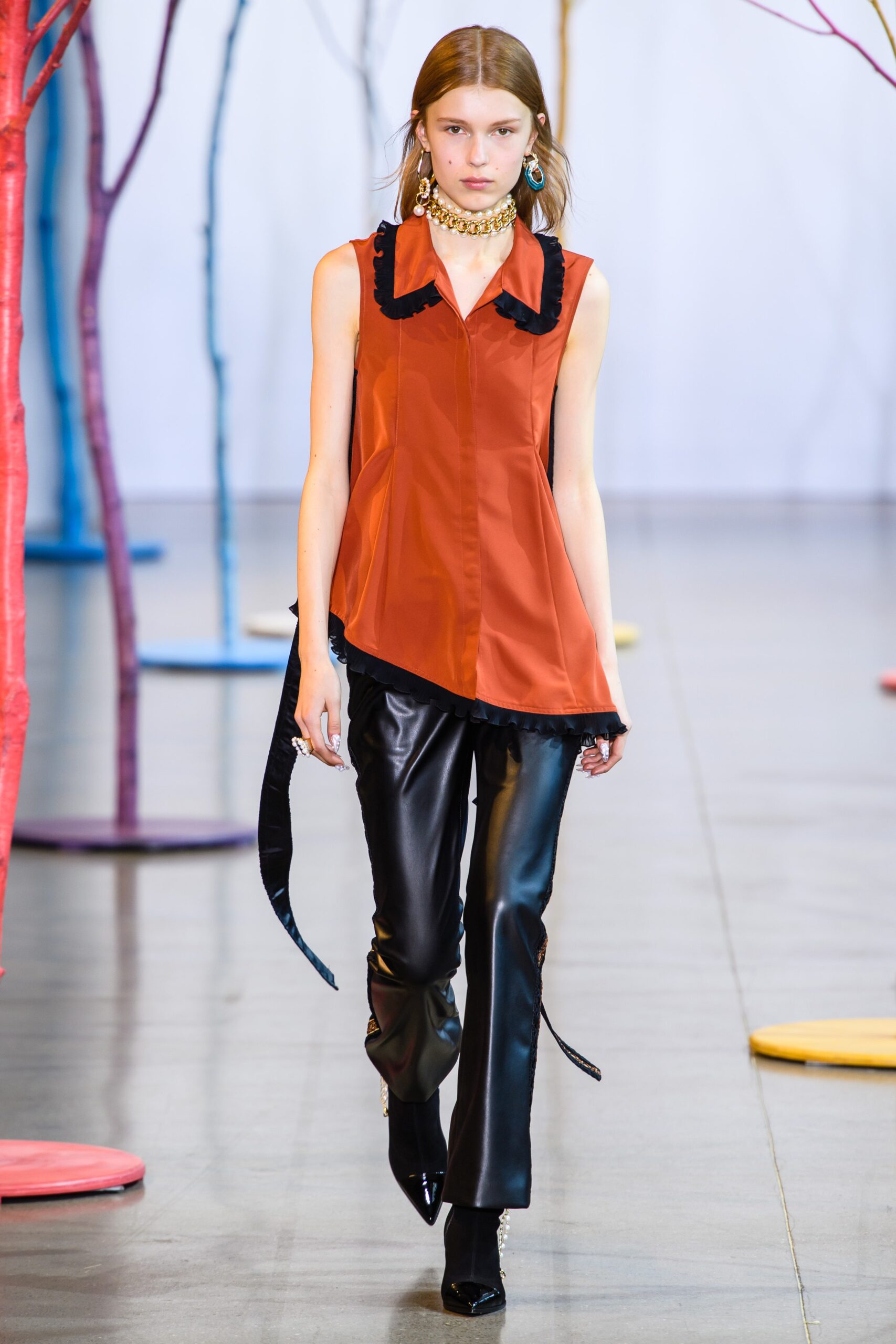 fitted orange silk top and black leather pants