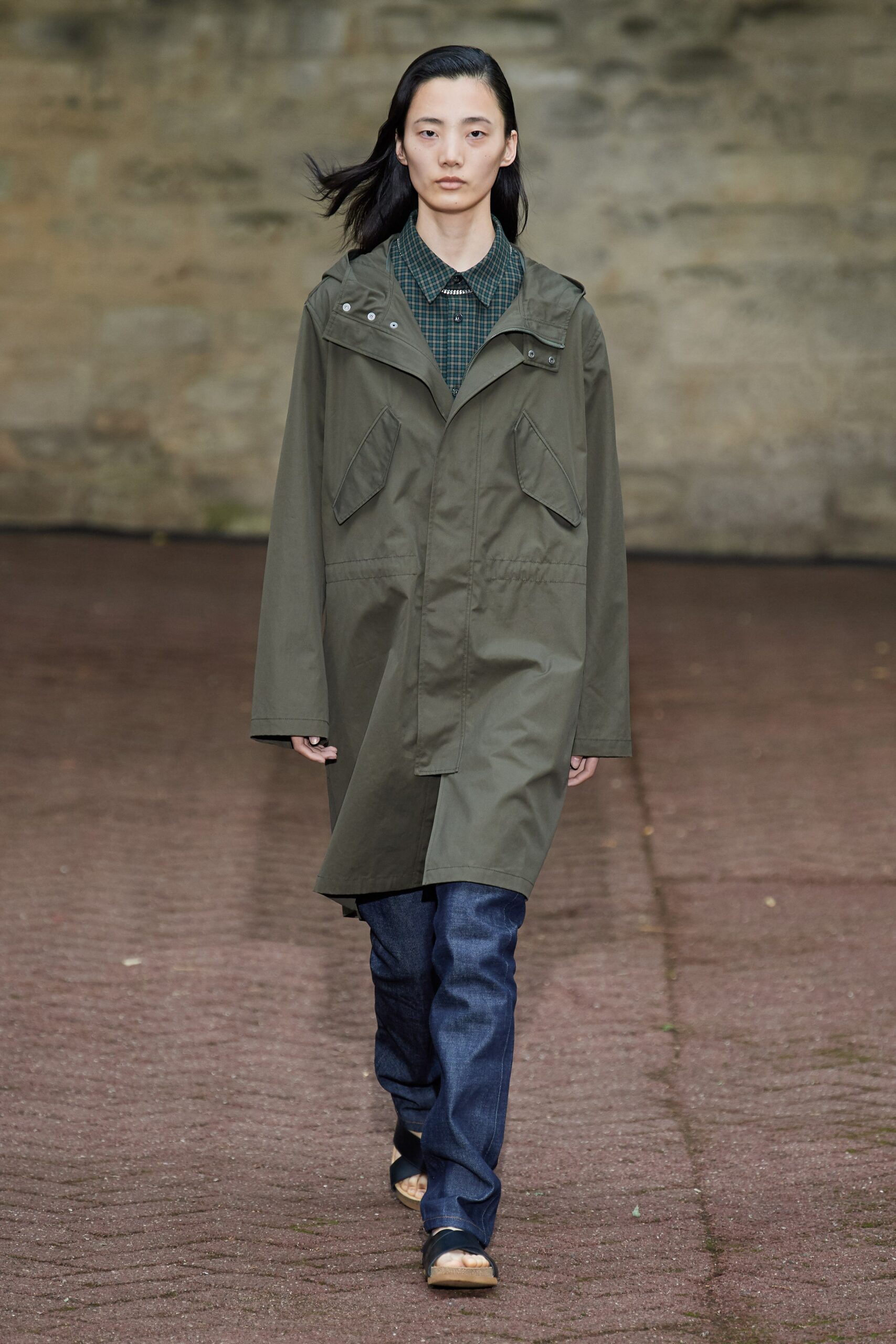 green coat blue shirt jeans