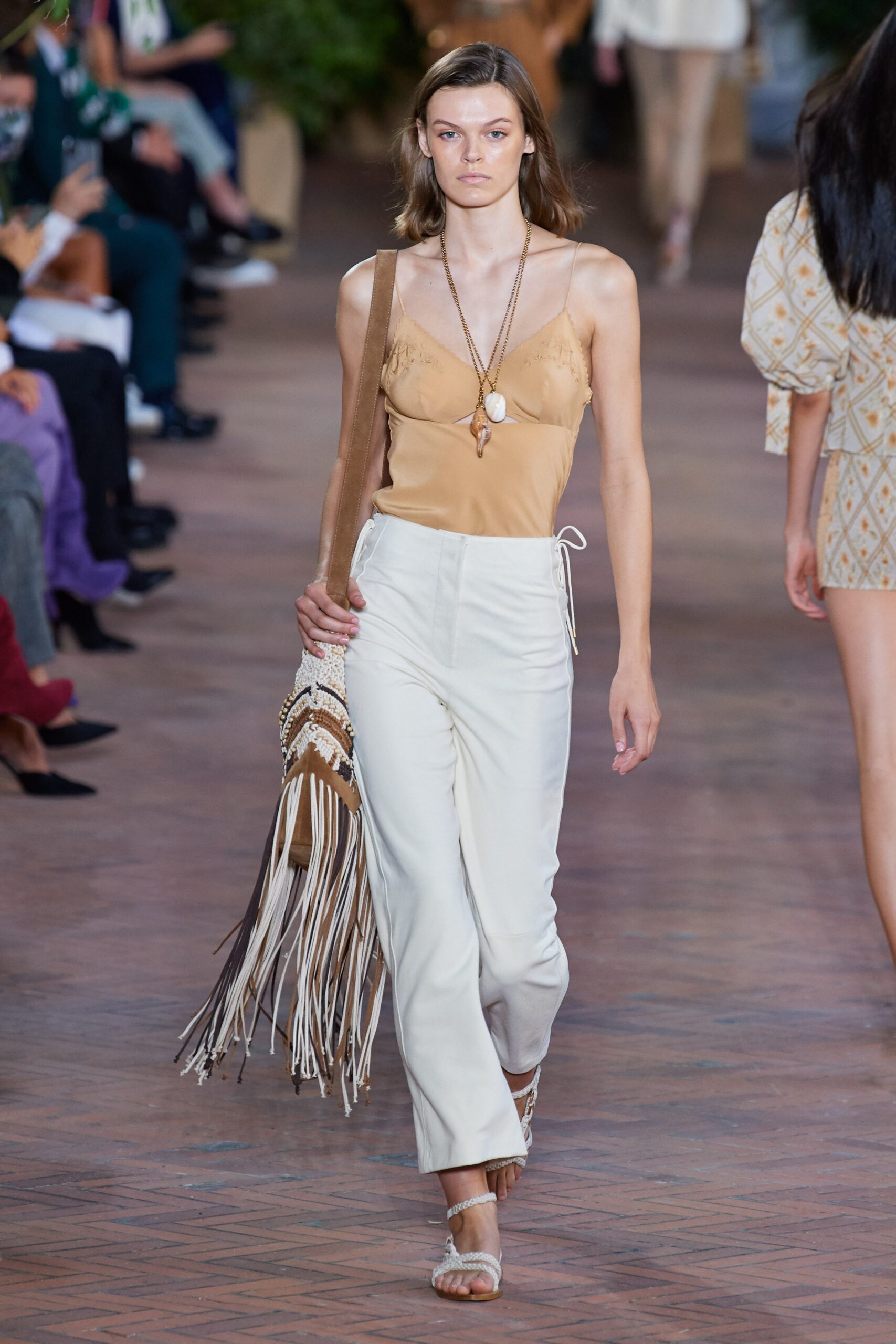 beige silk sleeveless top with white tailored pants