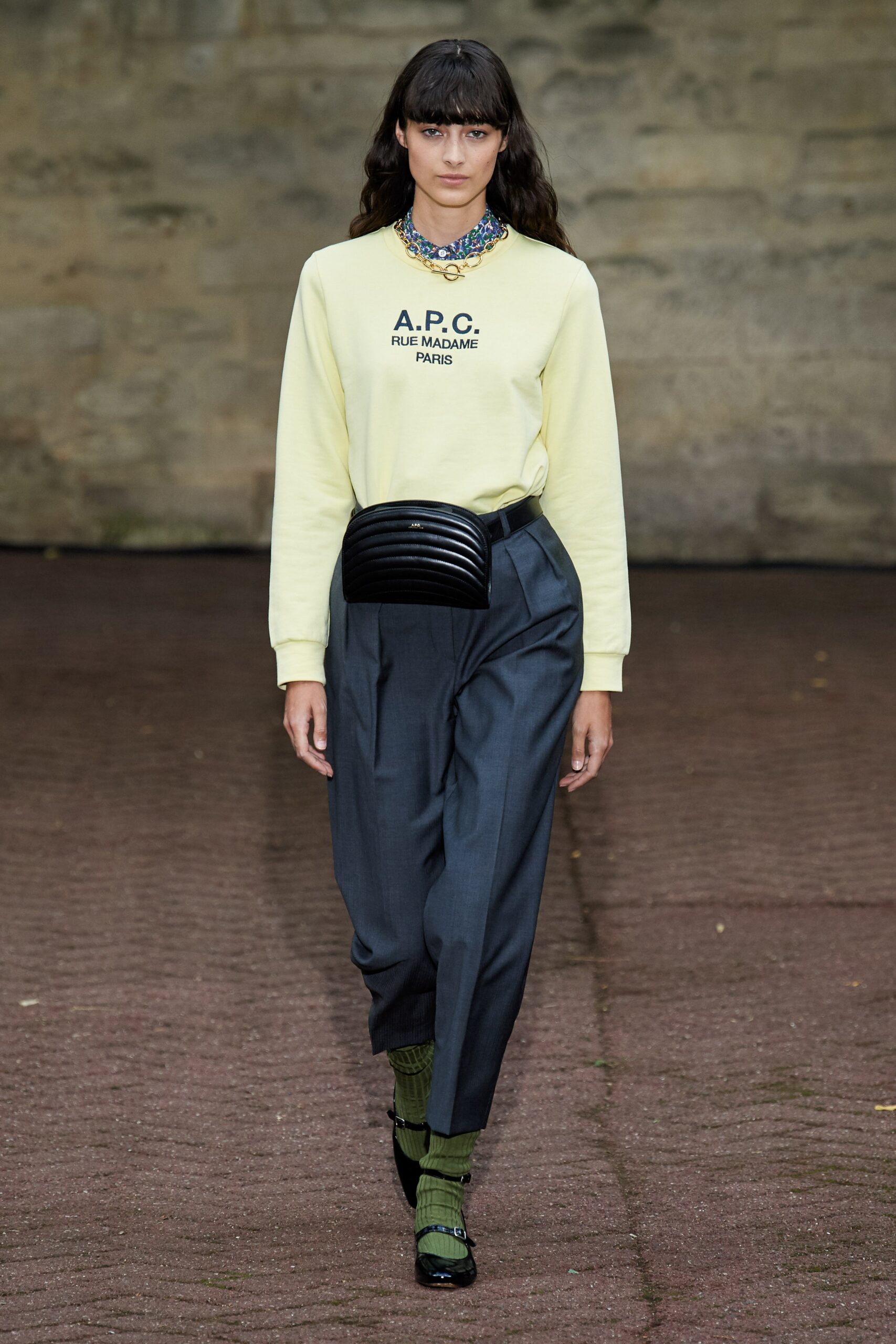yellow cotton sweater with gray tailored pants