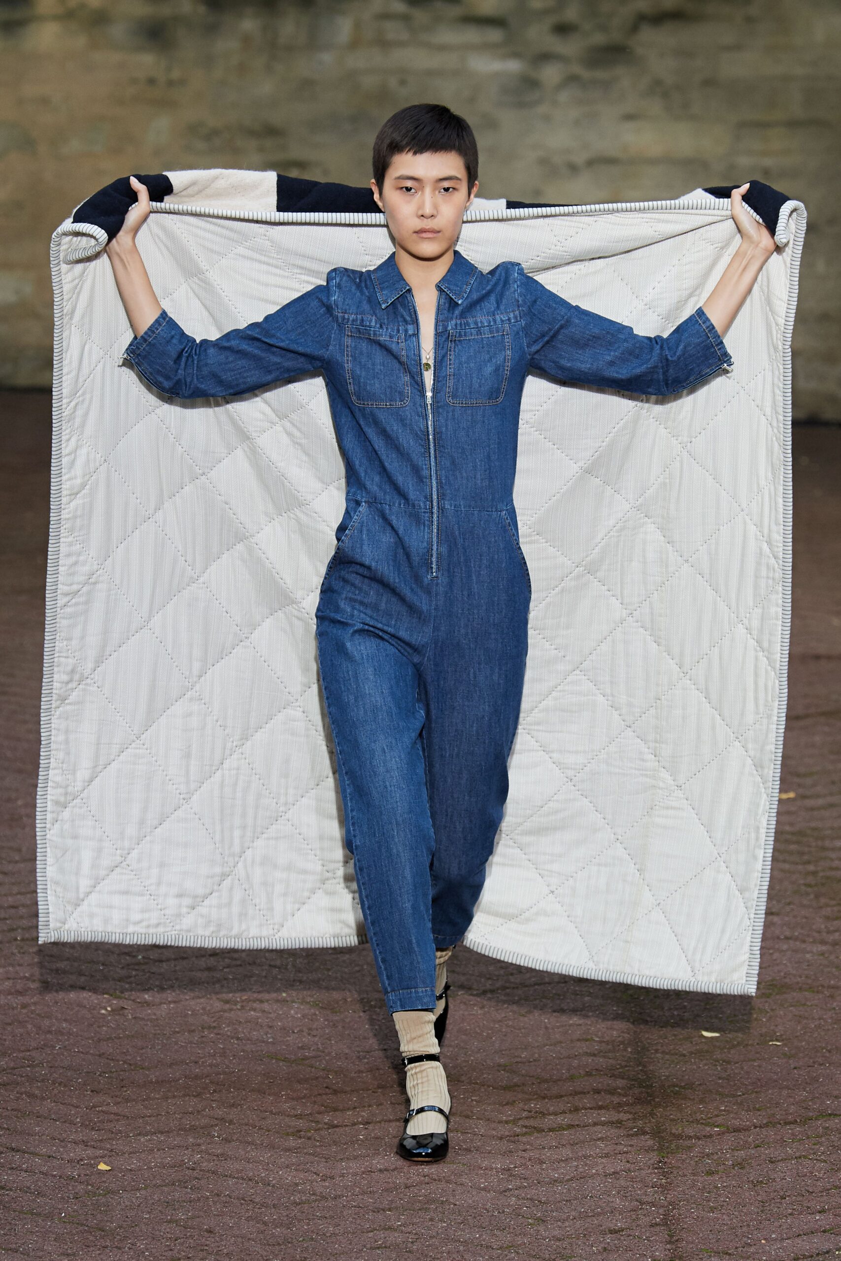 blue denim jumpsuit with white quilted cape