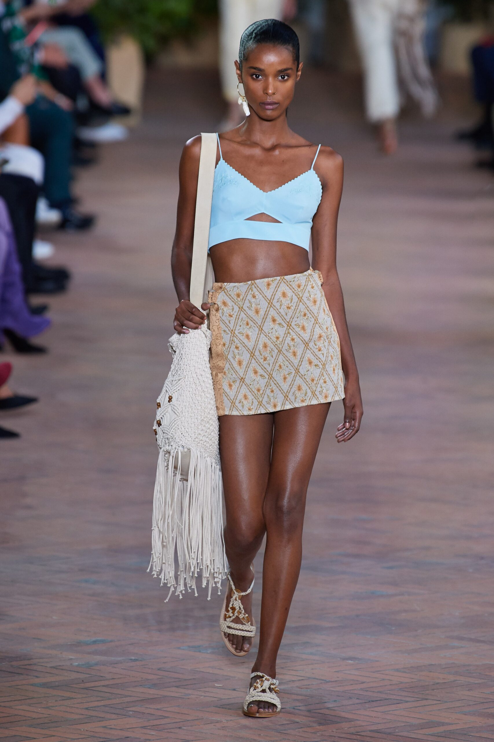 blue fitted top with beige pleated skirt