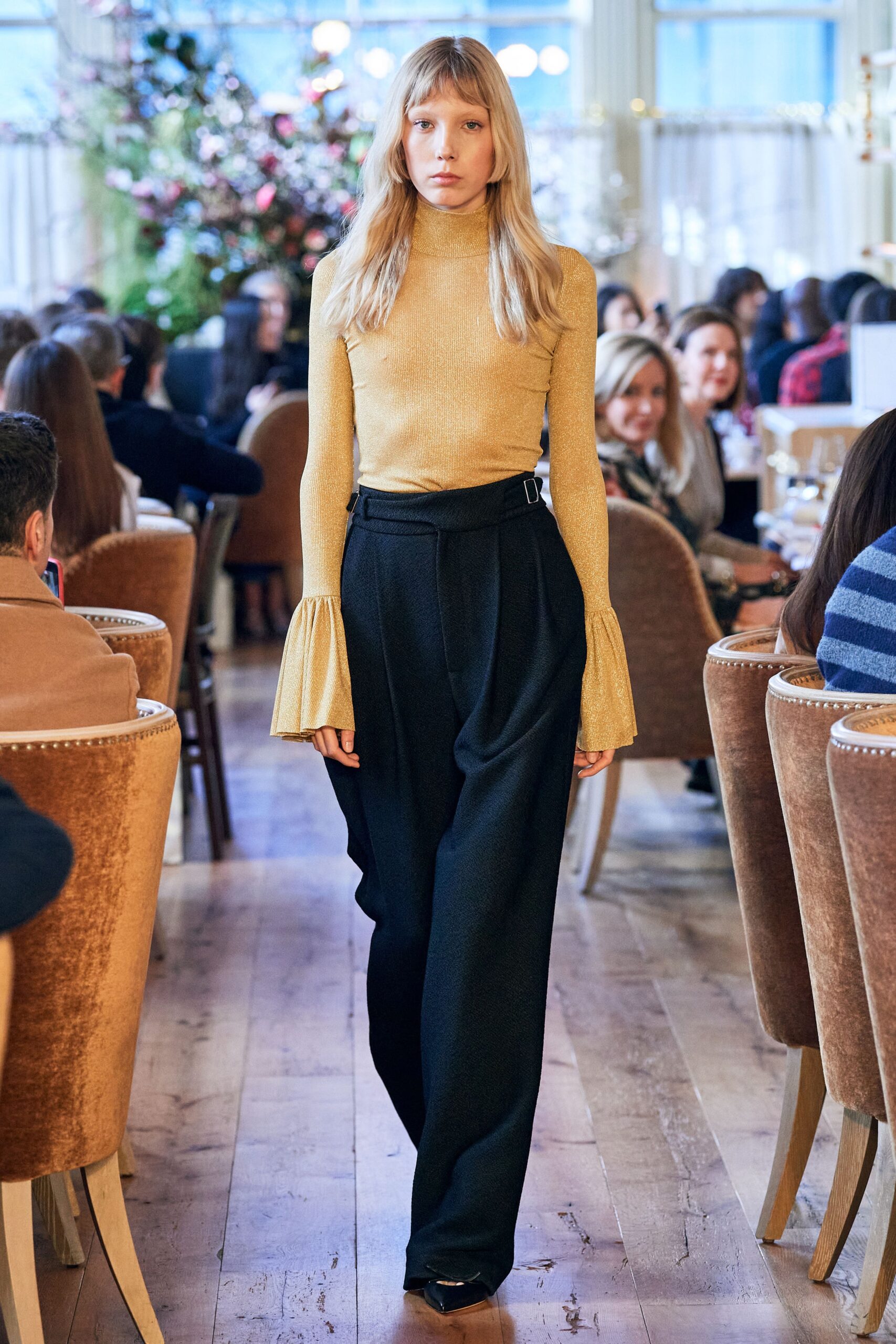 gold silk fitted top and black pants