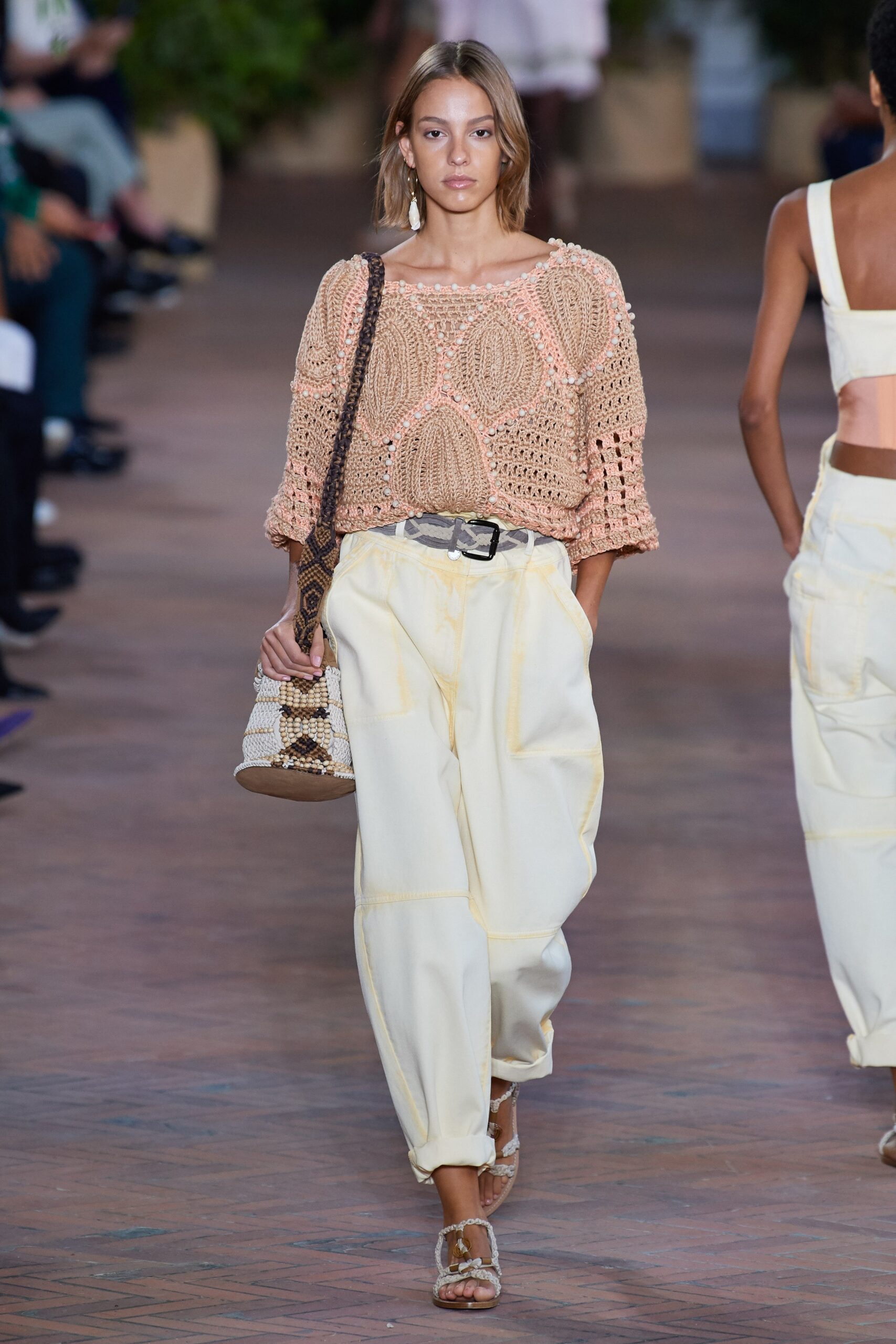 peach crochet top with white pants