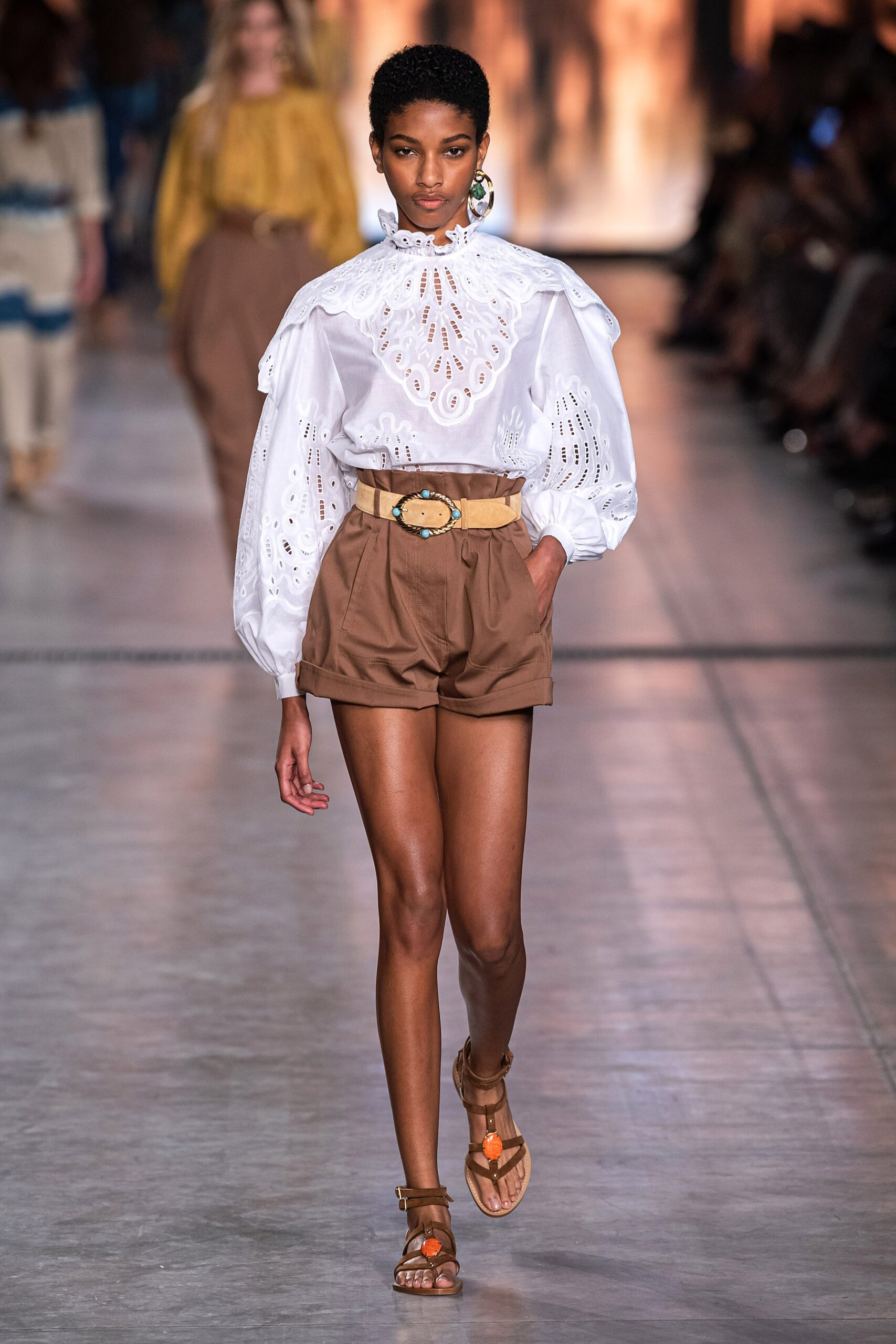 white embroidered blouse with brown shorts