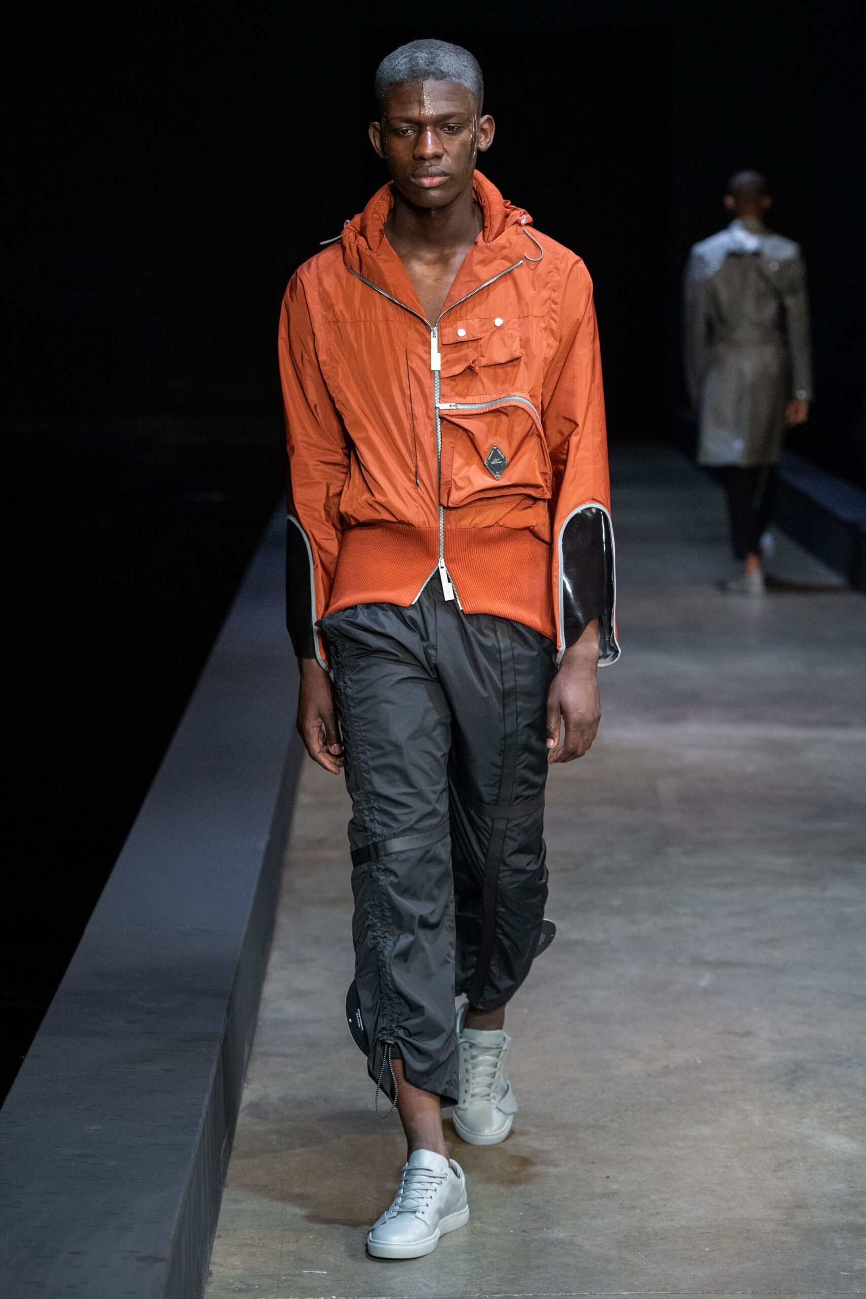 orange hooded jacket with black pants