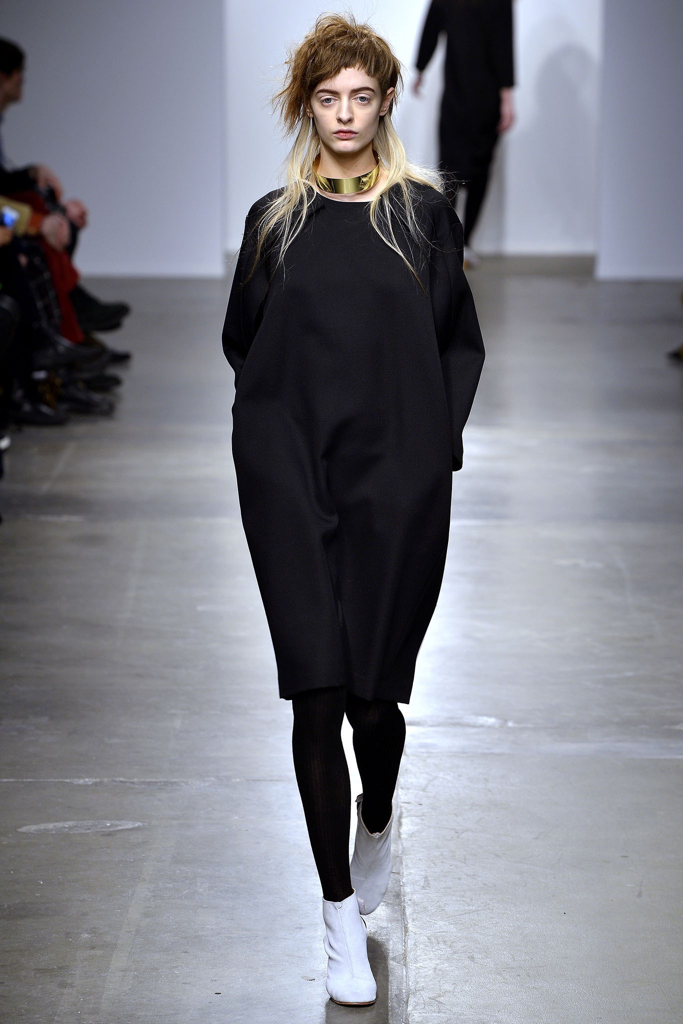 An oversized black dress with long sleeves and a crew neckline, perfect for a casual look.