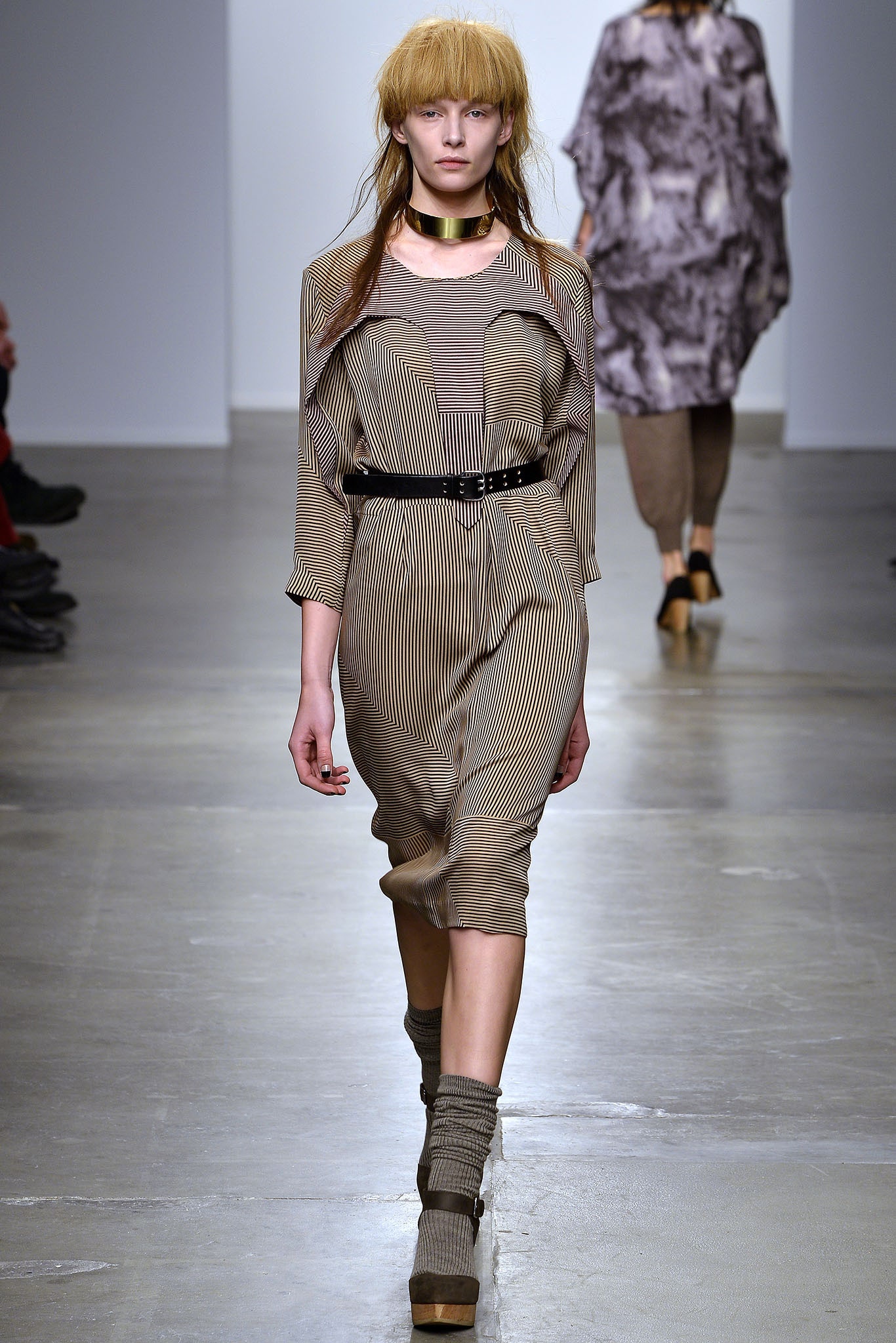 A fitted beige dress with long sleeves, a collared neckline, and a striped design.