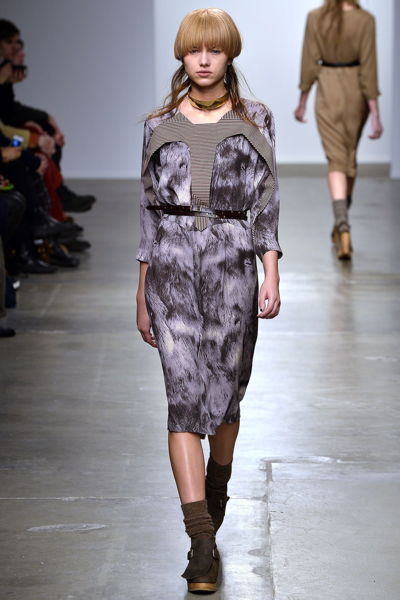 A relaxed gray silk dress with long sleeves and an asymmetric design detail.
