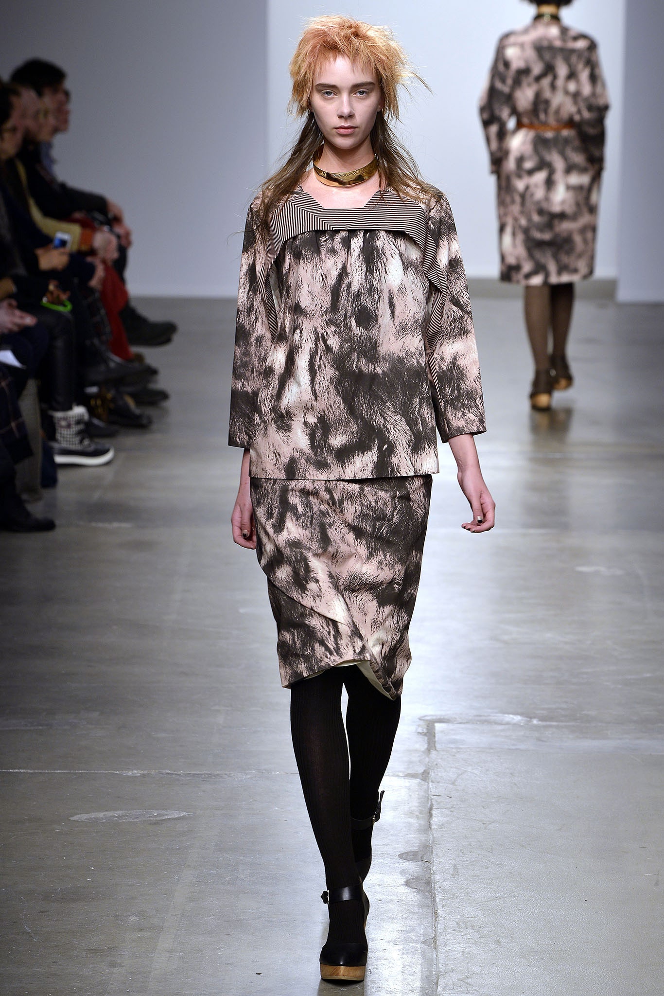 A fitted long-sleeve dress in brown and beige with a printed design and collared neckline.