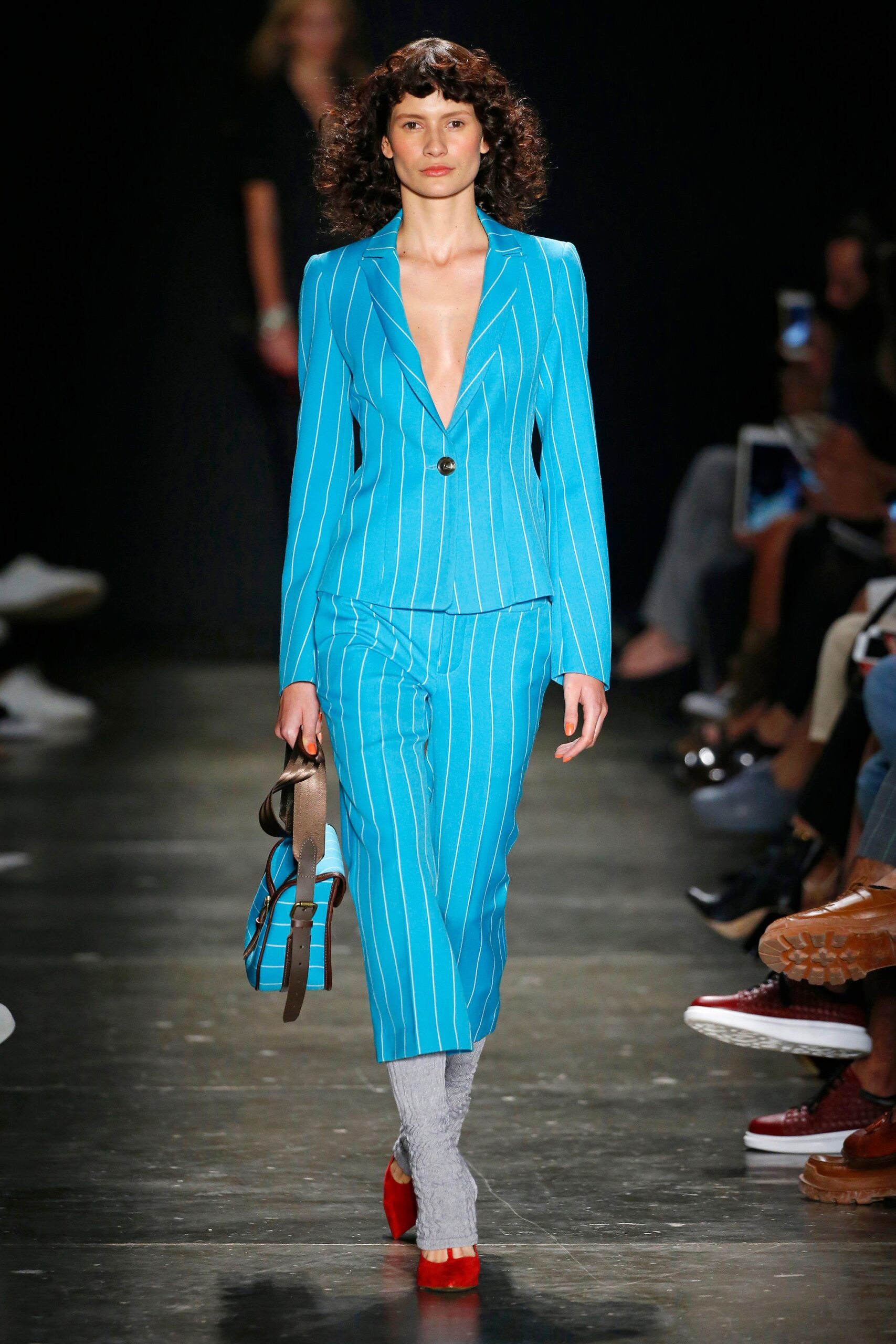 A fitted blue cotton suit with long sleeves and a V-neckline featuring a striped pattern.