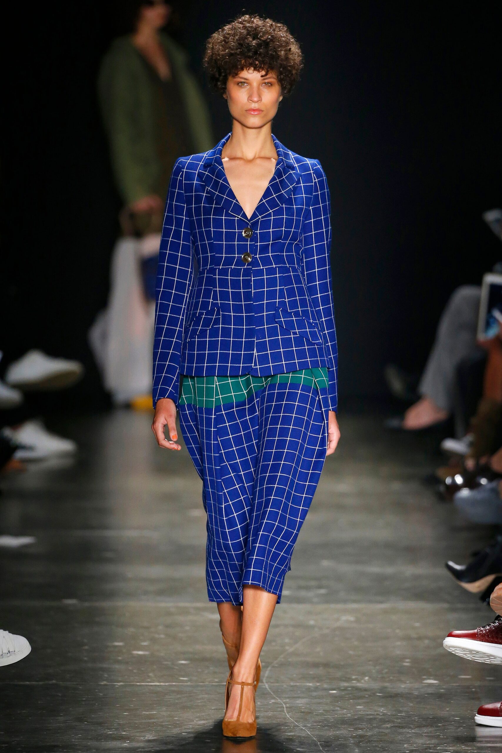 A tailored blue checked suit with long sleeves and a collared design.