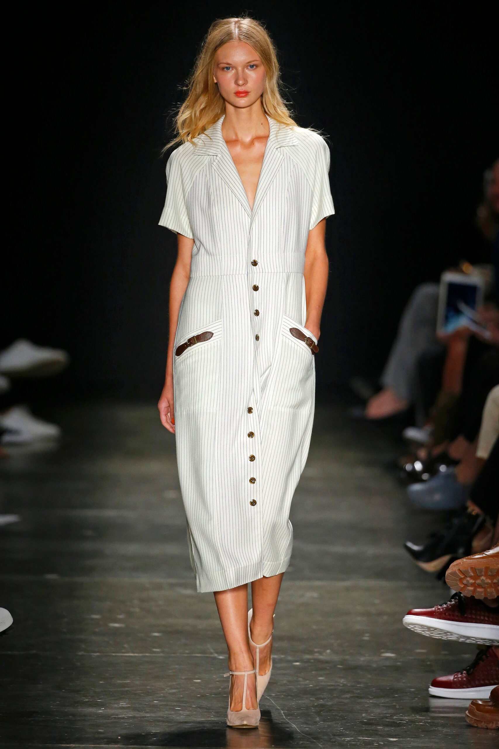 A fitted white striped dress with short sleeves and a collared neckline featuring button details.