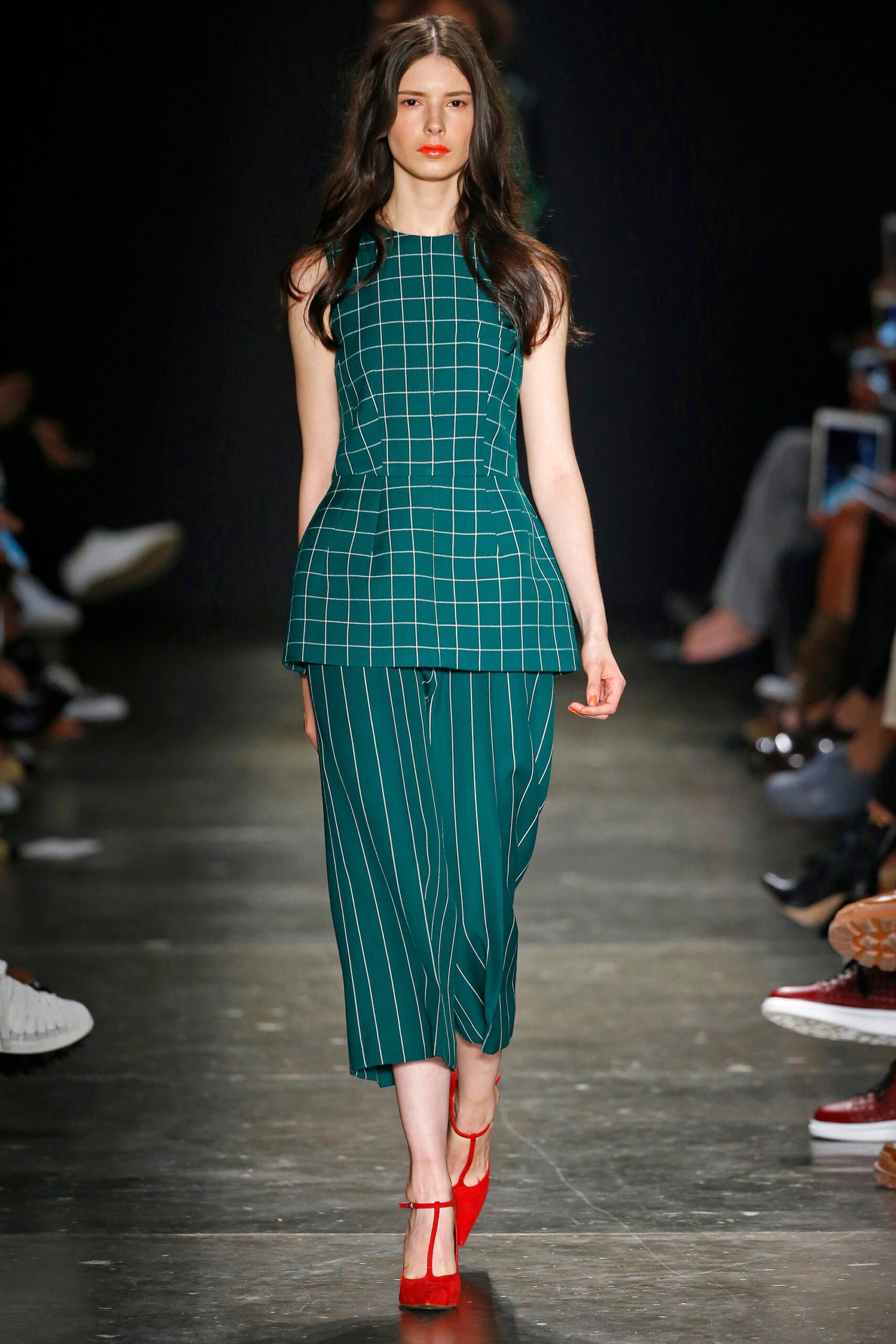 A fitted green striped sleeveless top paired with matching pants, featuring an asymmetric design.