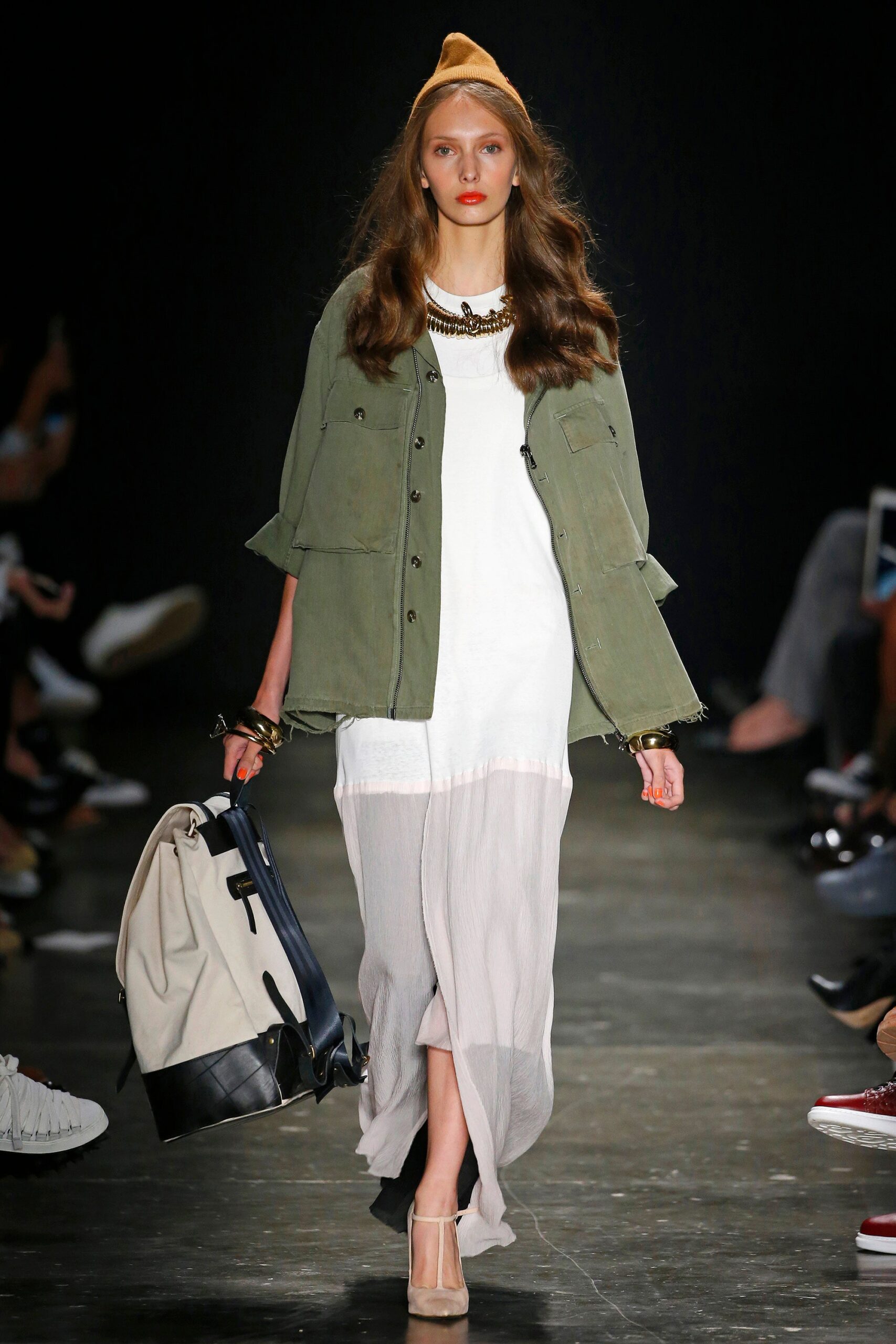 A relaxed white dress layered with a green collared jacket, featuring an asymmetric design.