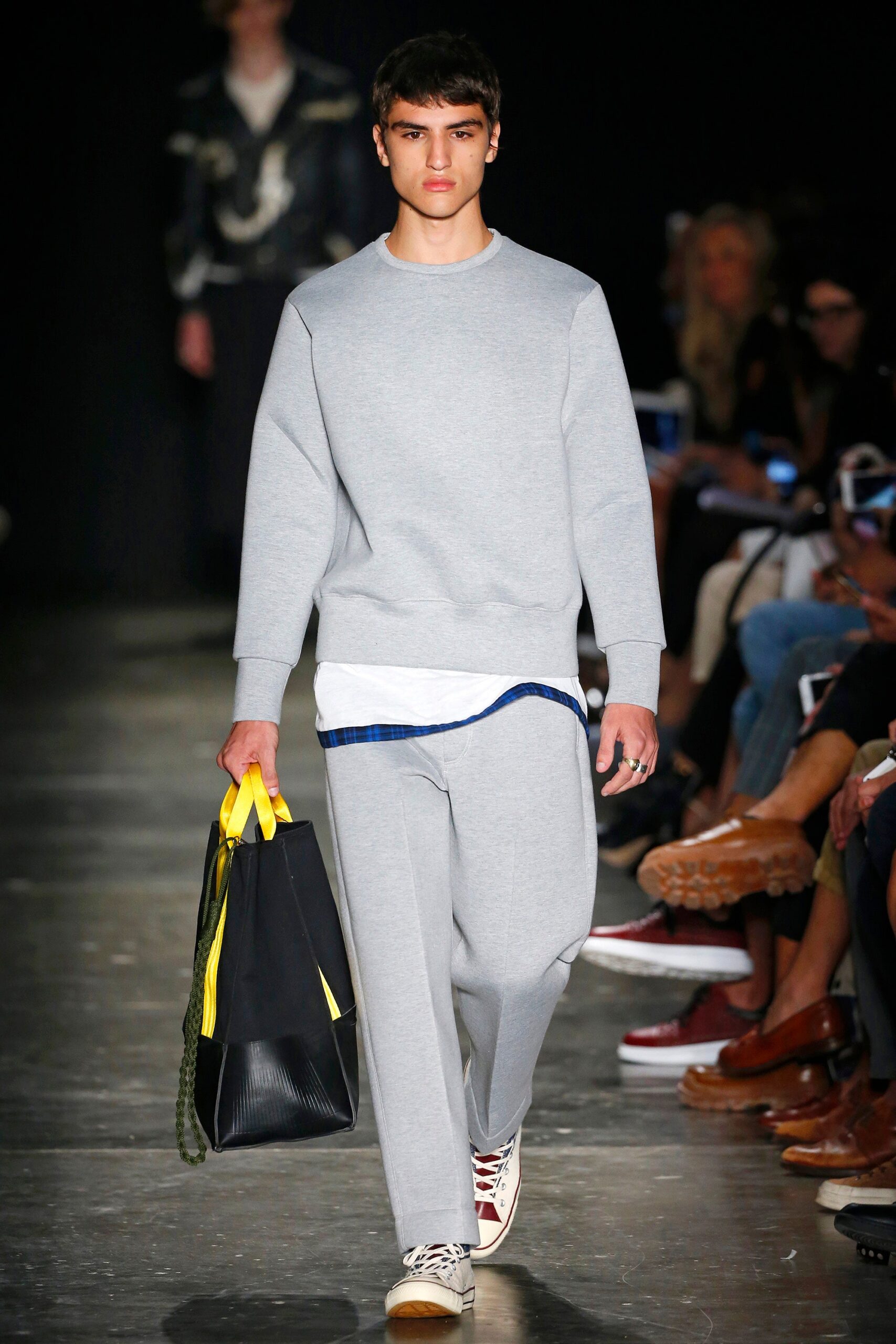 A relaxed gray cotton sweater with long sleeves paired with straight-leg pants.
