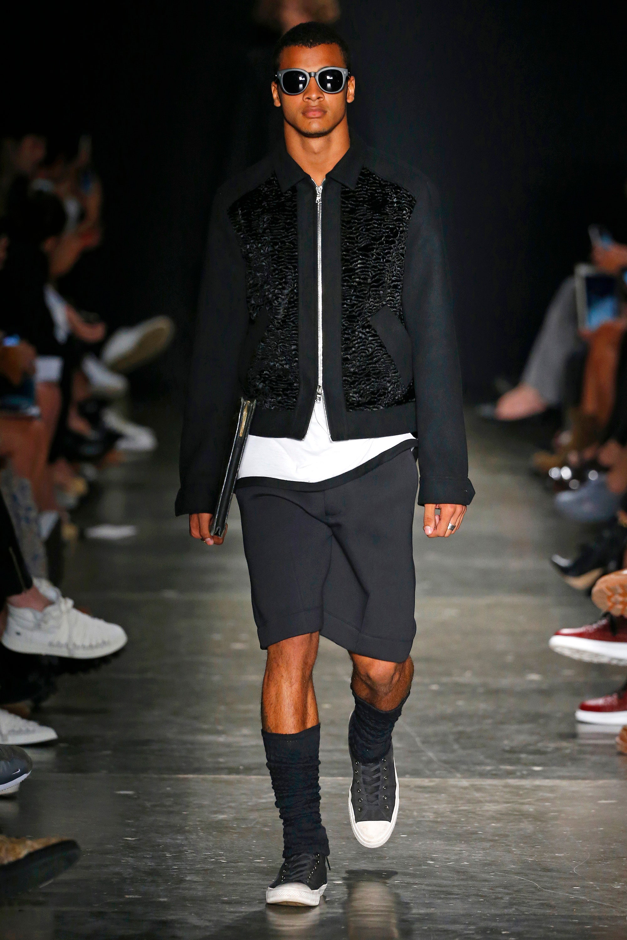 A relaxed black jacket with short sleeves paired with black shorts, perfect for a casual look.