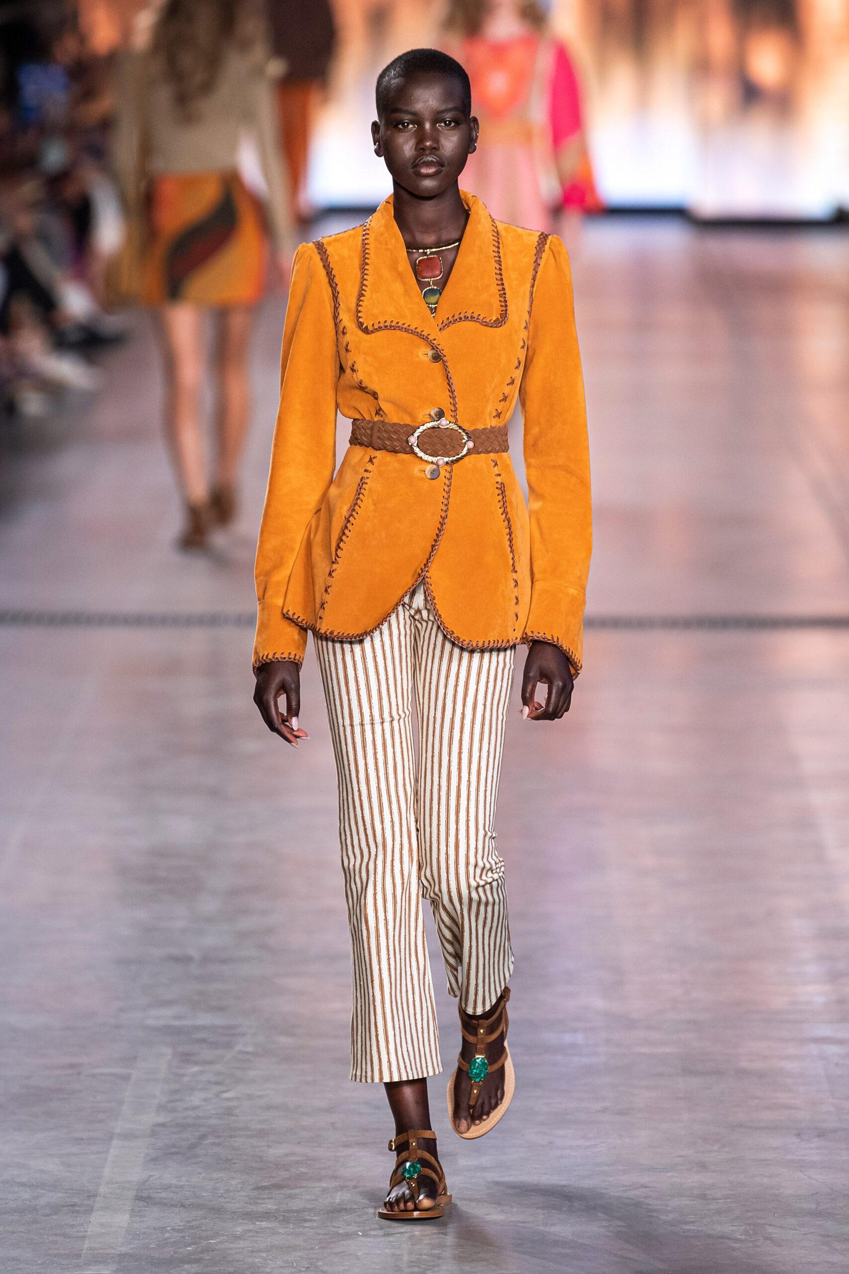 orange suede fitted jacket with striped pants